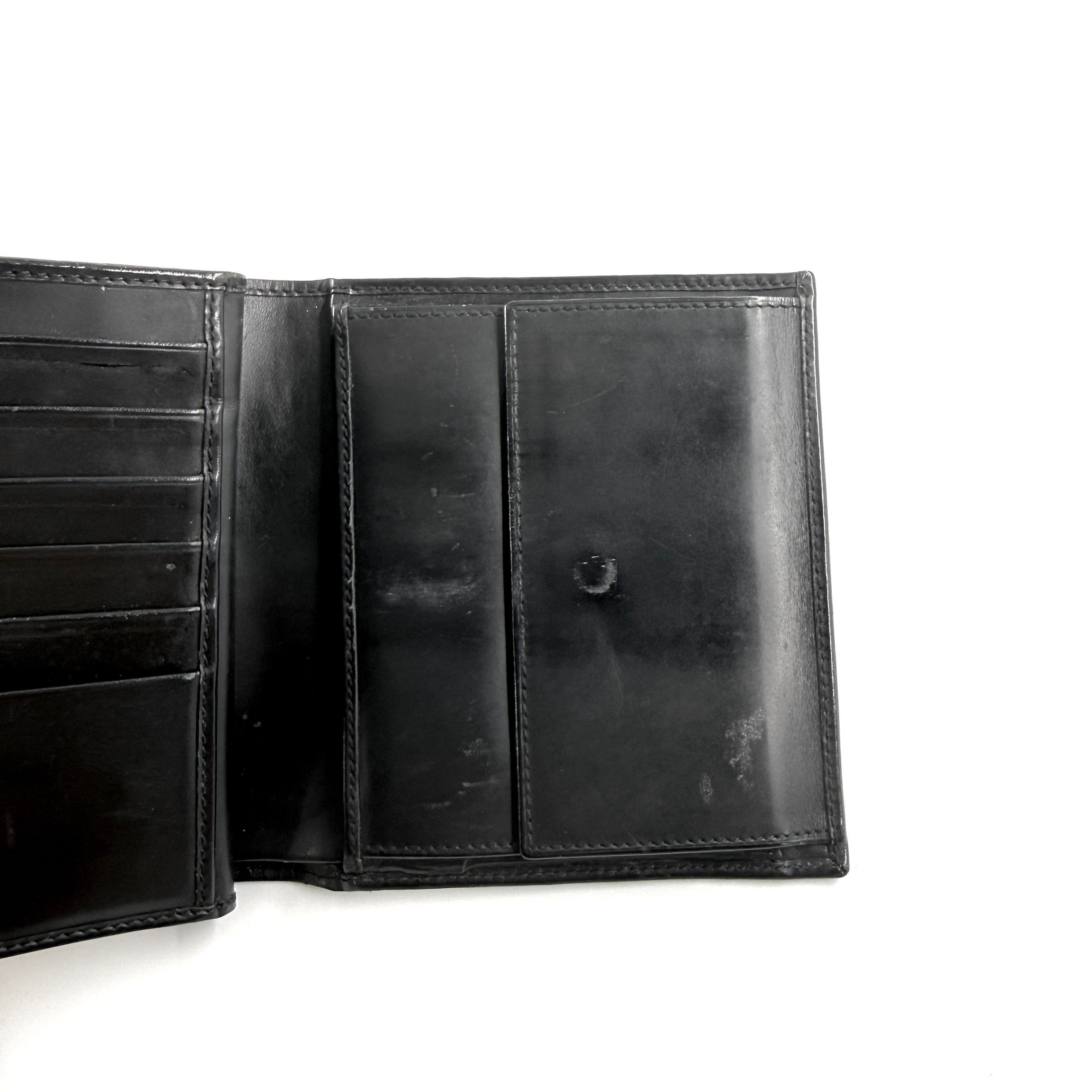 Gucci G Logo Bifold Wallet in black leather featuring a bold geometric G plaque and meticulously stitched edges.