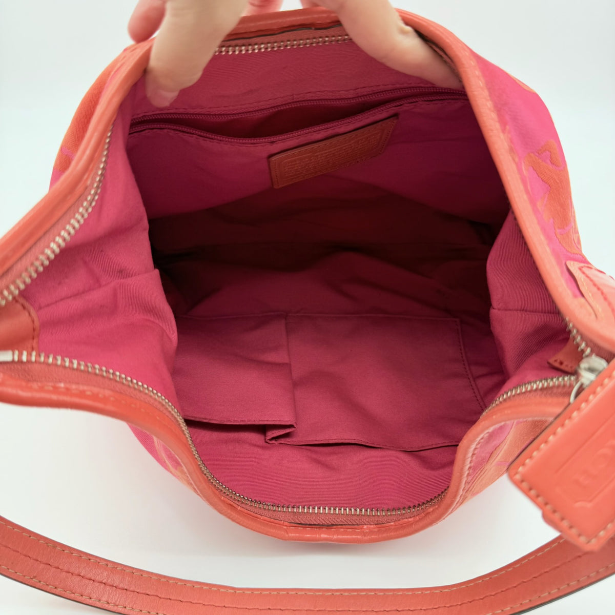 Coach pink and orange Horse & Carriage sateen hobo shoulder bag with detachable strap and leather trim.