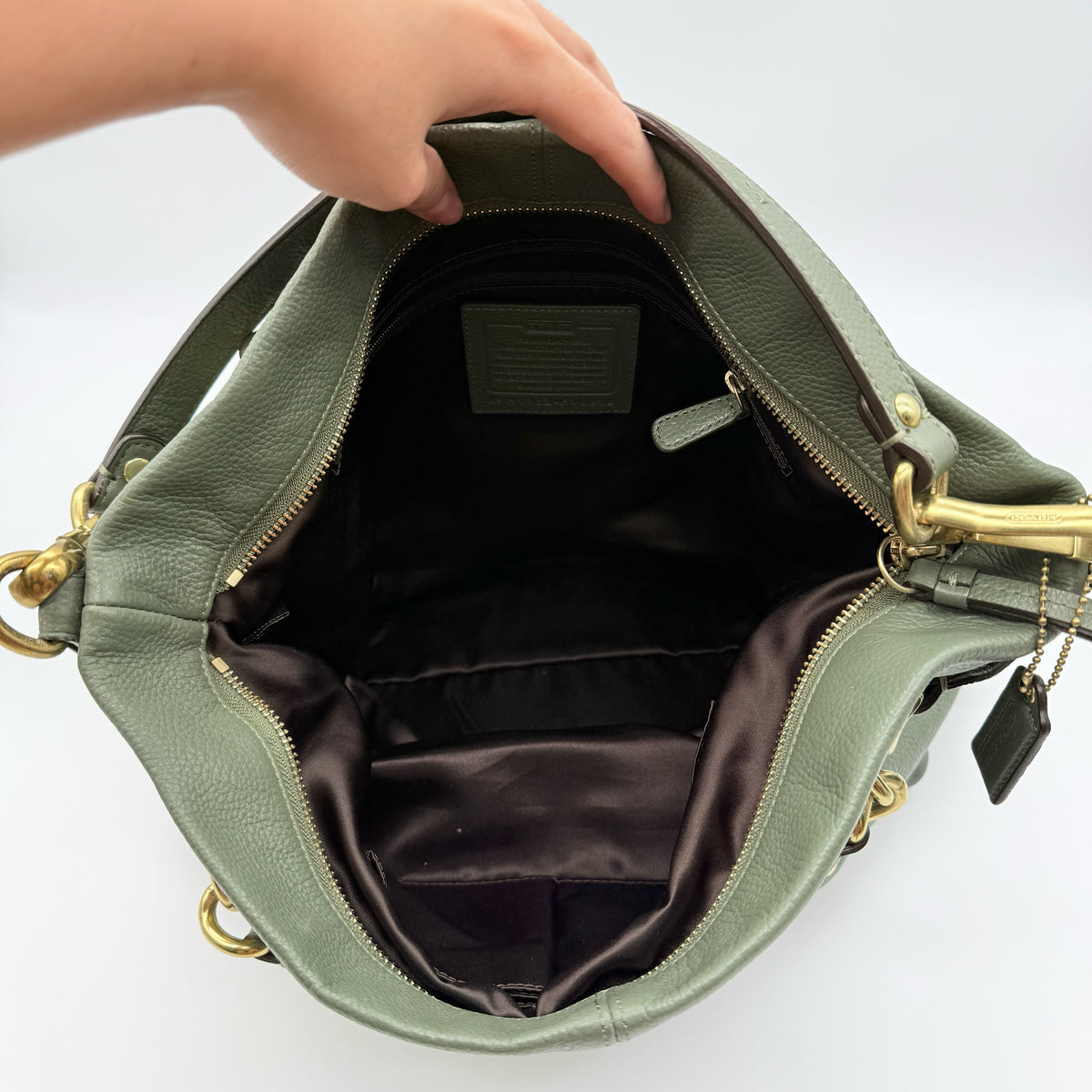 Coach Brooke Large Hobo Shoulder Bag in olive green pebbled leather with brass hardware, shown on a white background.