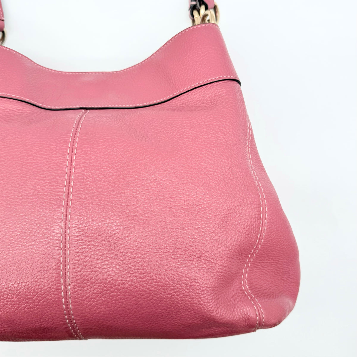 Coach Lexy Shoulder Bag in pink pebbled leather with gold hardware and dual straps, shown against a white background.