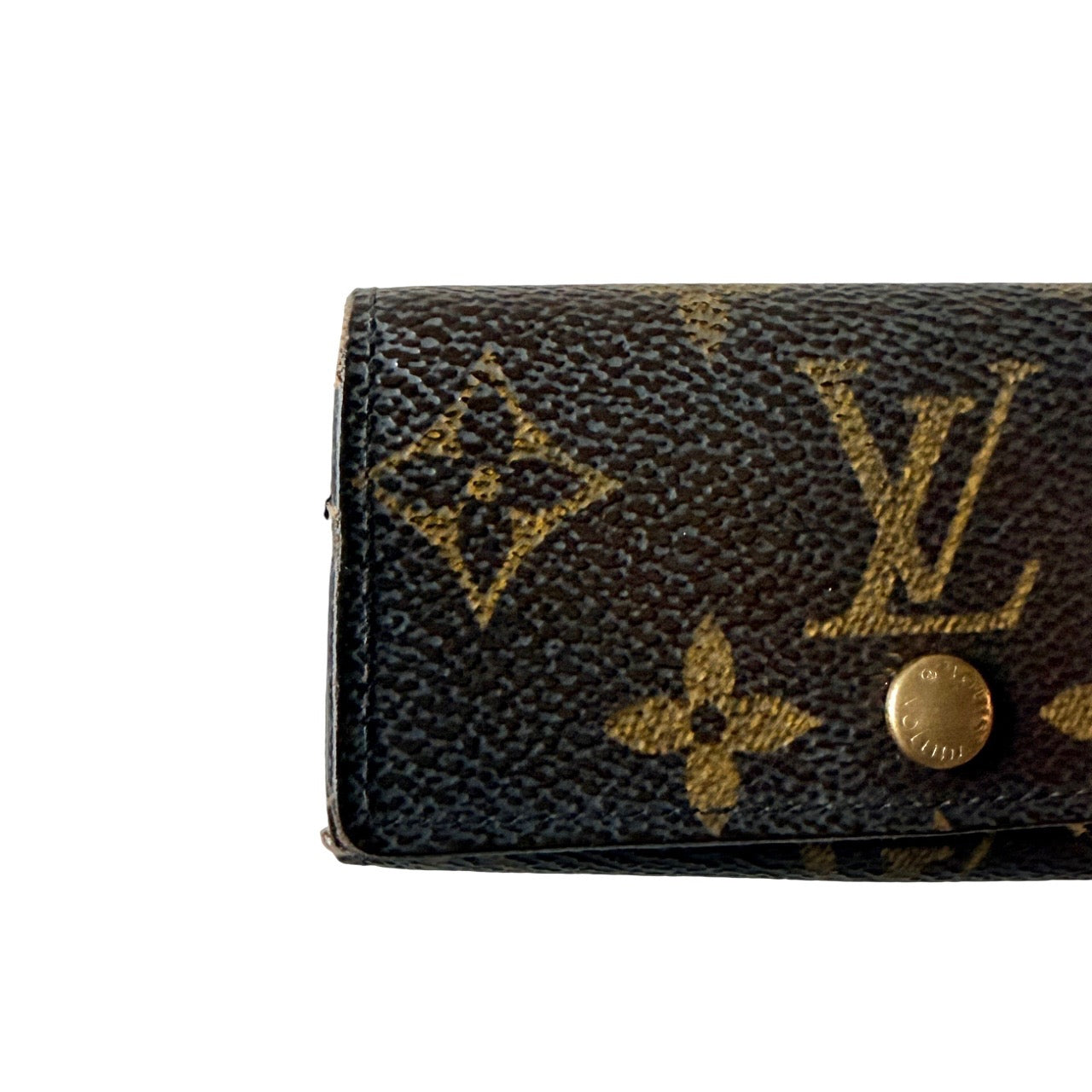 Louis Vuitton monogram key case in brown with gold-tone snap closure and classic LV pattern on coated canvas.