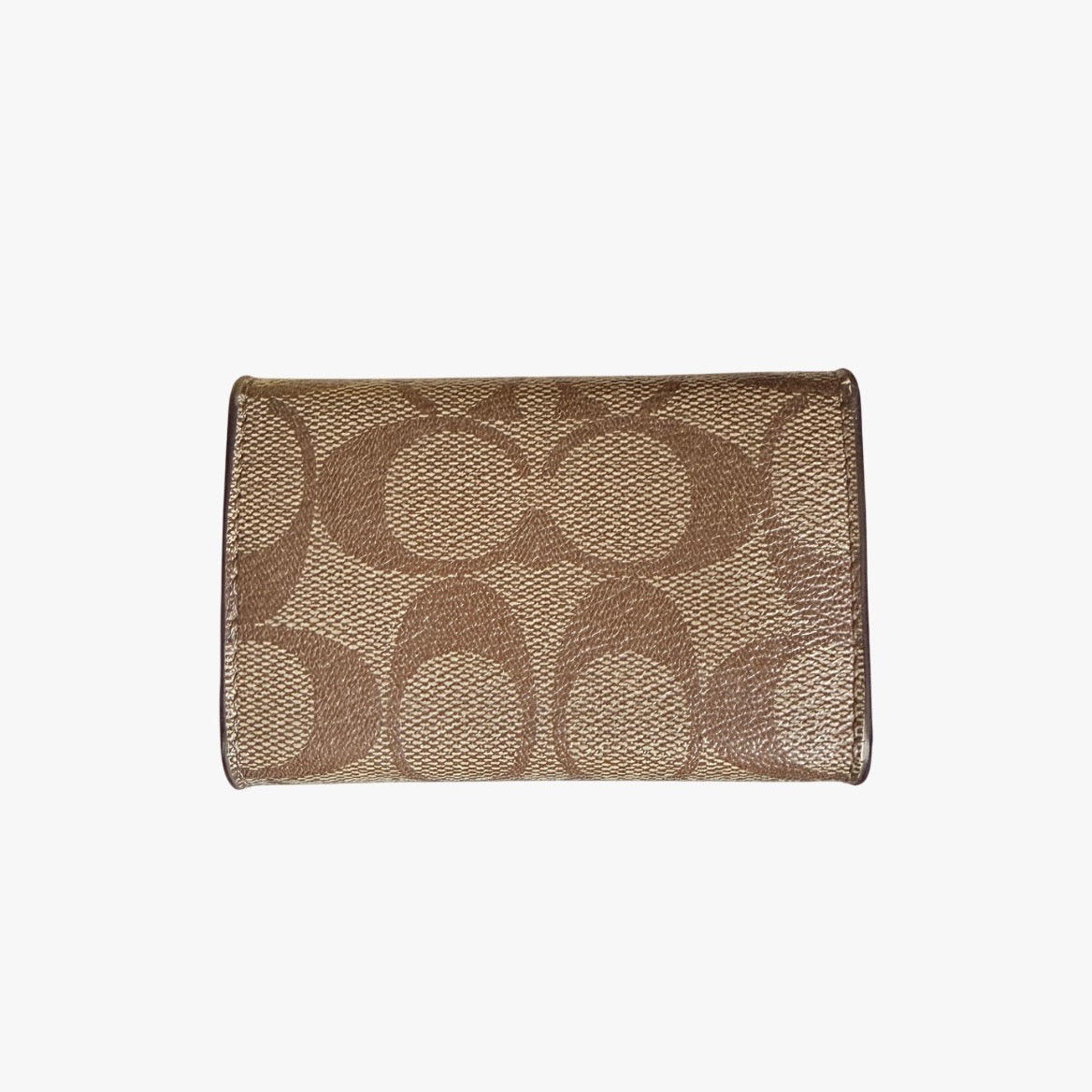 Coach Signature Canvas Key Case in beige with gold-tone logo and signature monogram pattern, shown in a front view.