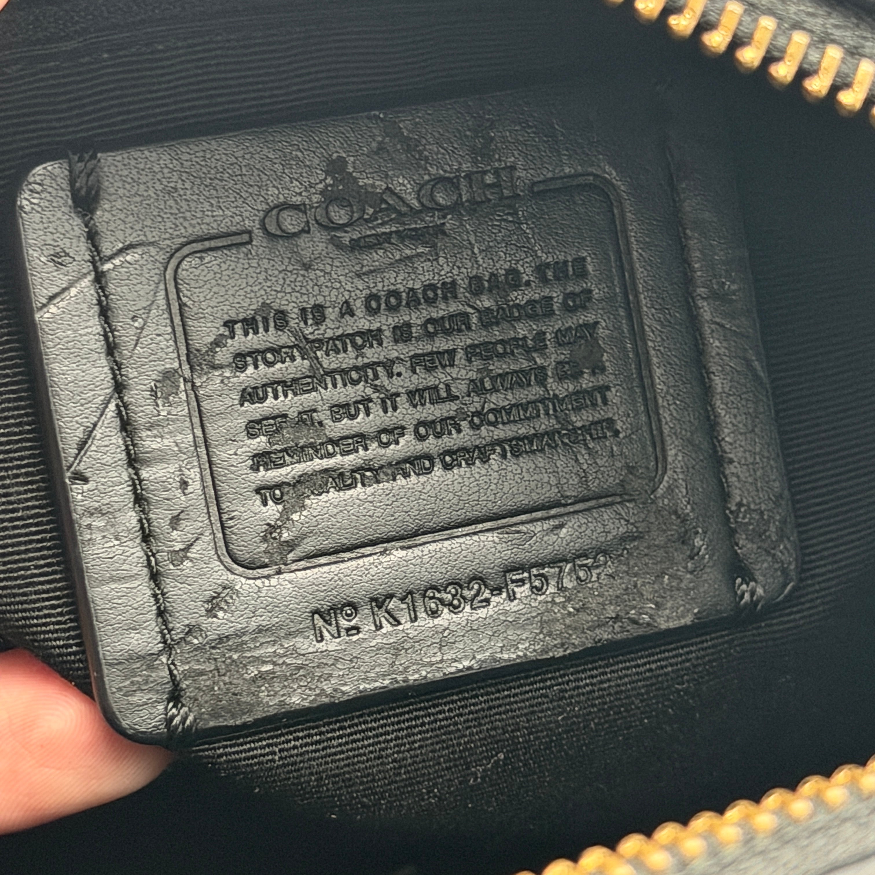 Front-facing image of the Coach Mini Bennett Boston Bag in black grained leather with gold hardware.