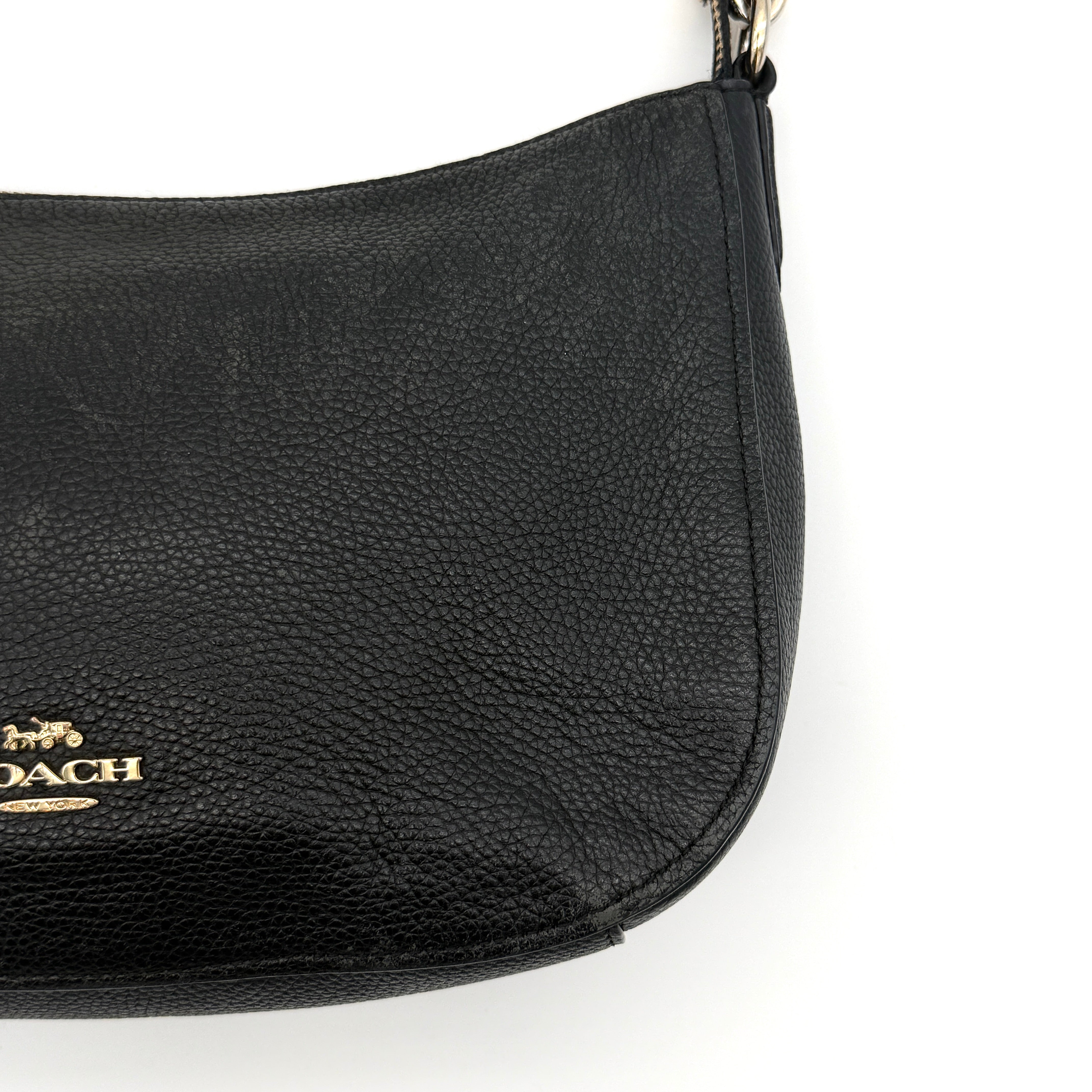 Coach Sutton Hobo Shoulder Bag in black grained leather with gold-tone hardware and zip closure.