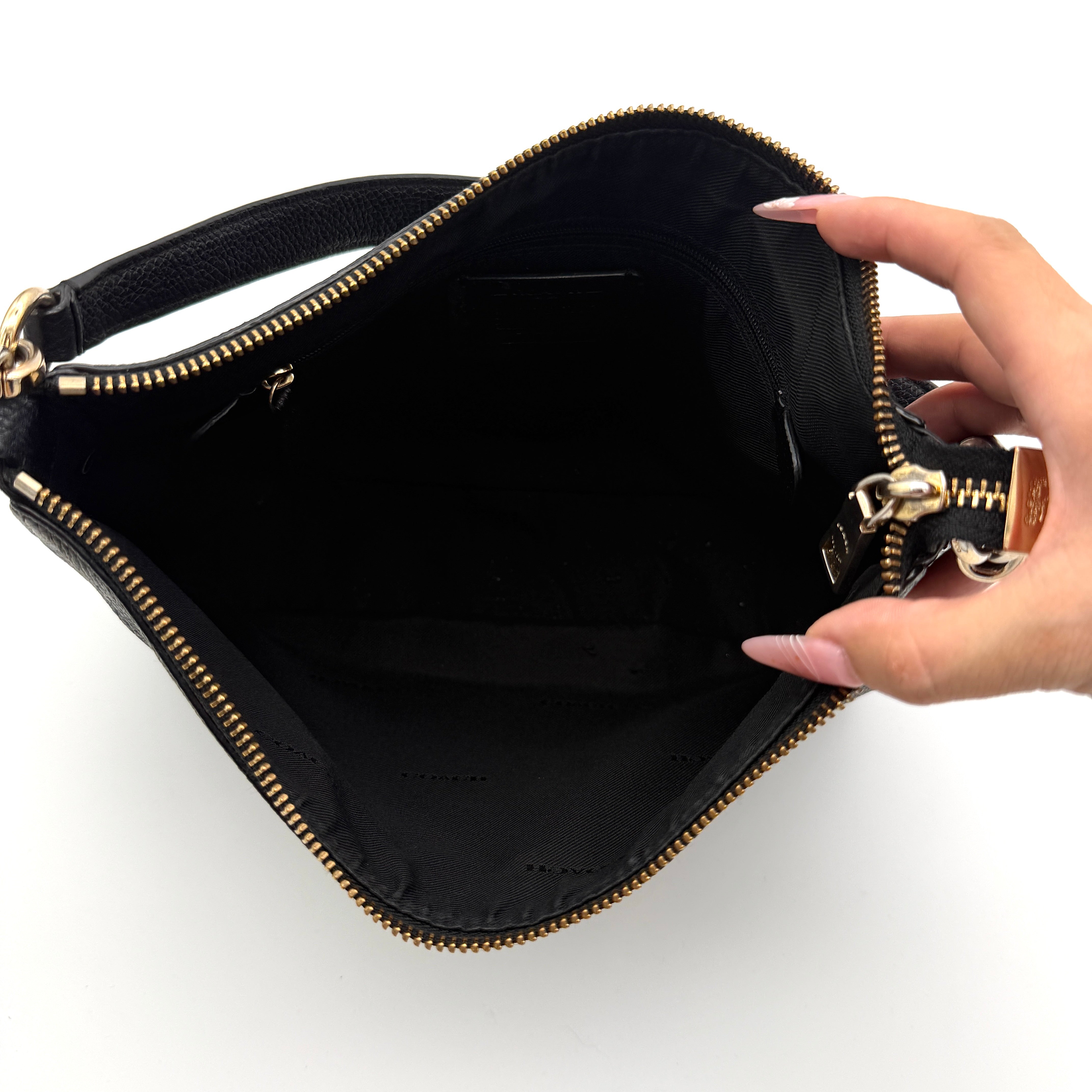 Coach Sutton Hobo Shoulder Bag in black grained leather with gold-tone hardware and zip closure.