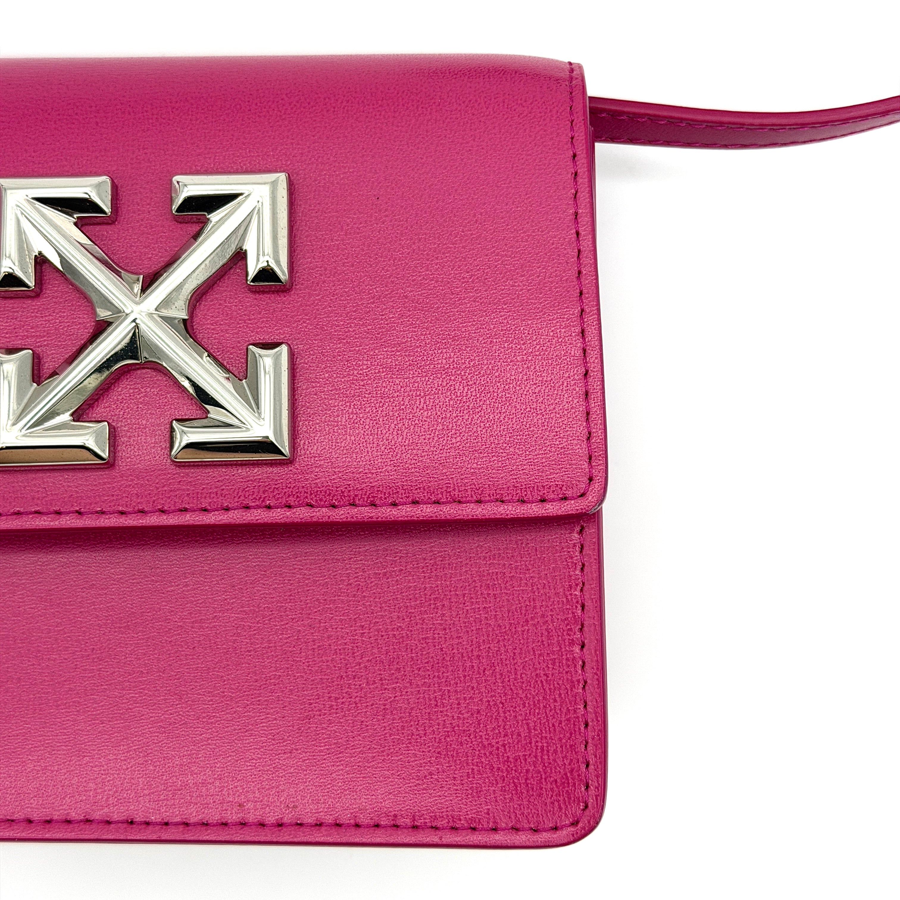 Off-White Jitney 0.7 Crossbody Bag in pink leather with silver-tone arrow logo and adjustable strap, shown against a white background.