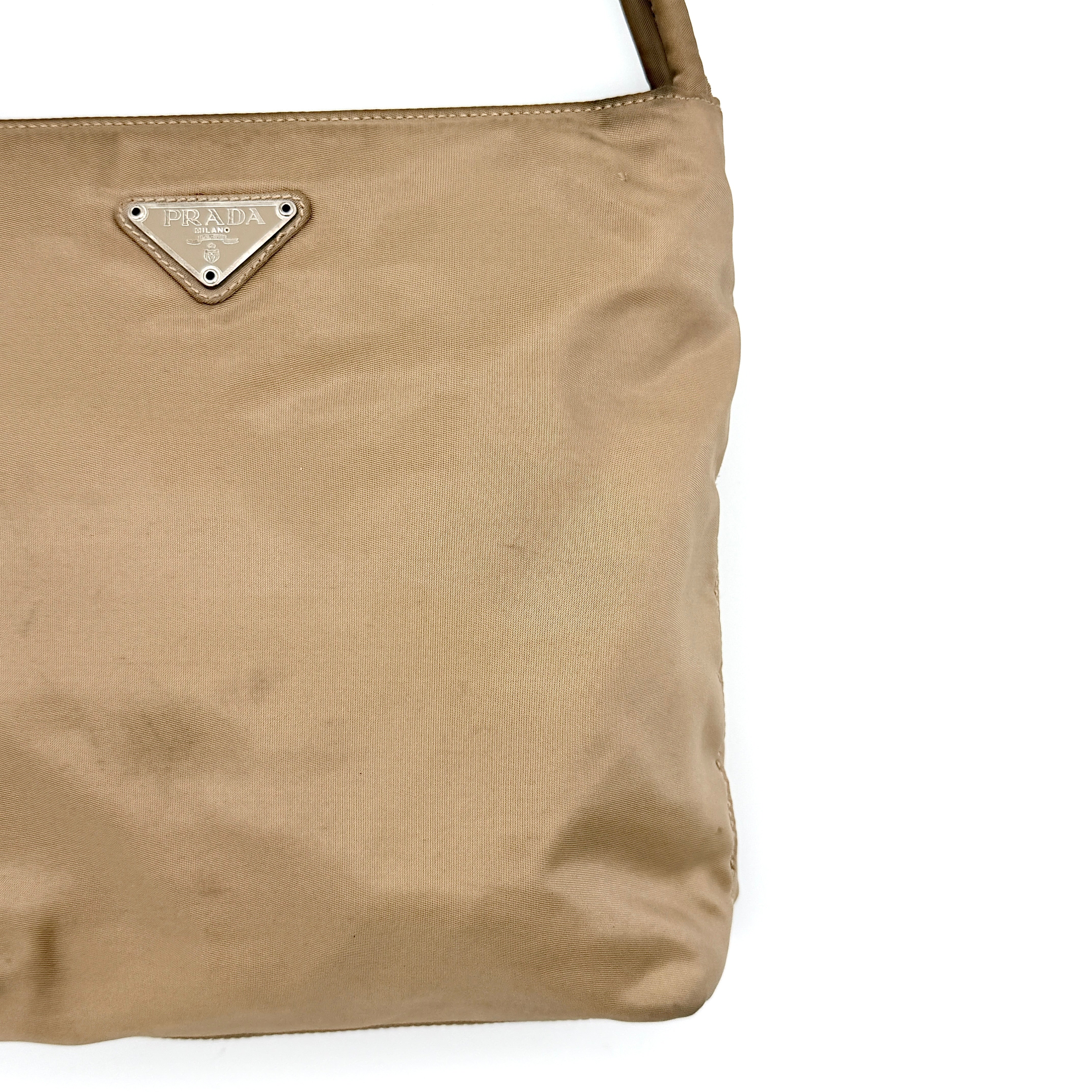 Prada Tessuto nylon tote bag in beige with silver-tone logo plaque and dual handles.