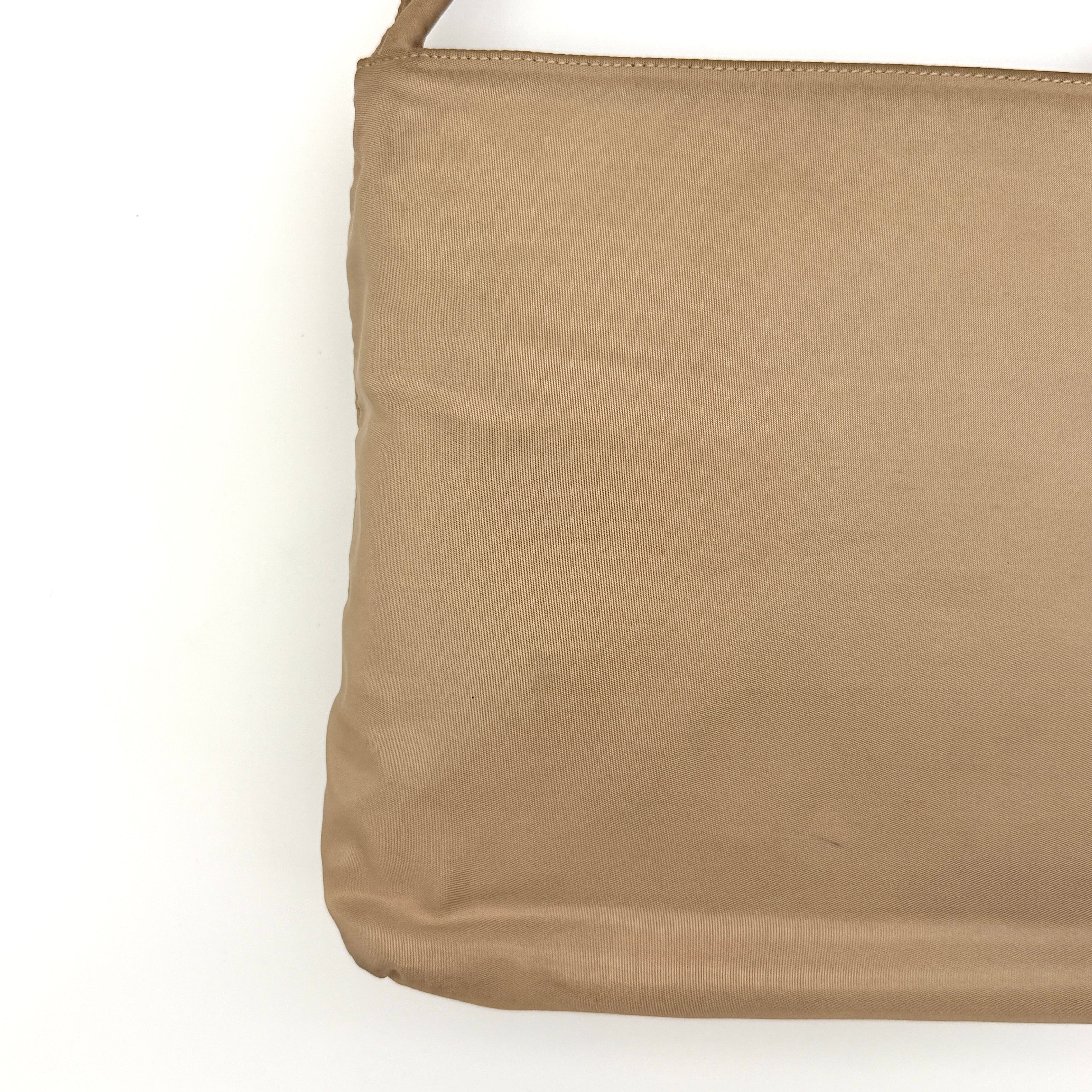 Prada Tessuto nylon tote bag in beige with silver-tone logo plaque and dual handles.