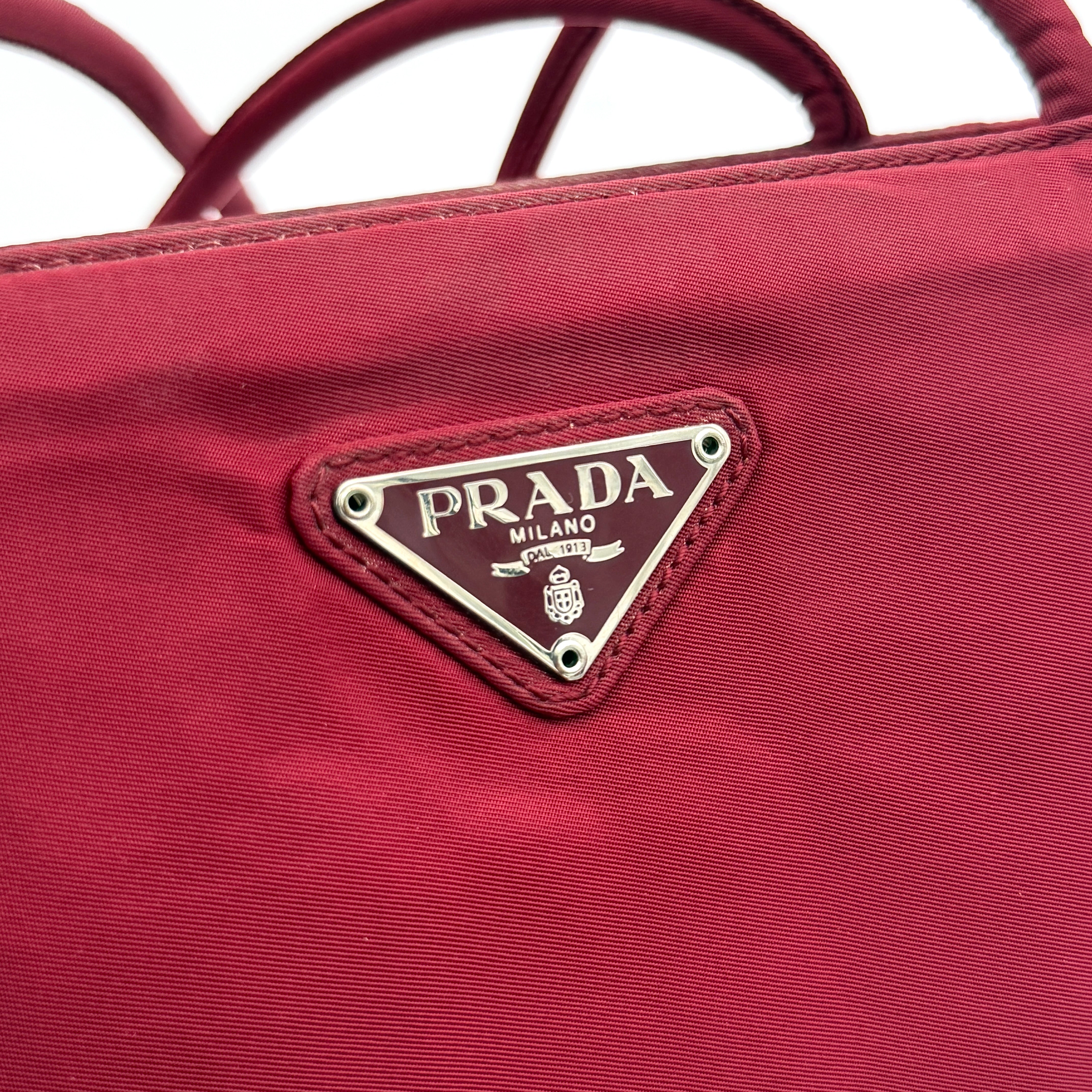 Red Prada Tessuto Nylon Tote Bag with double shoulder straps and classic enamel logo, displayed against a white background.
