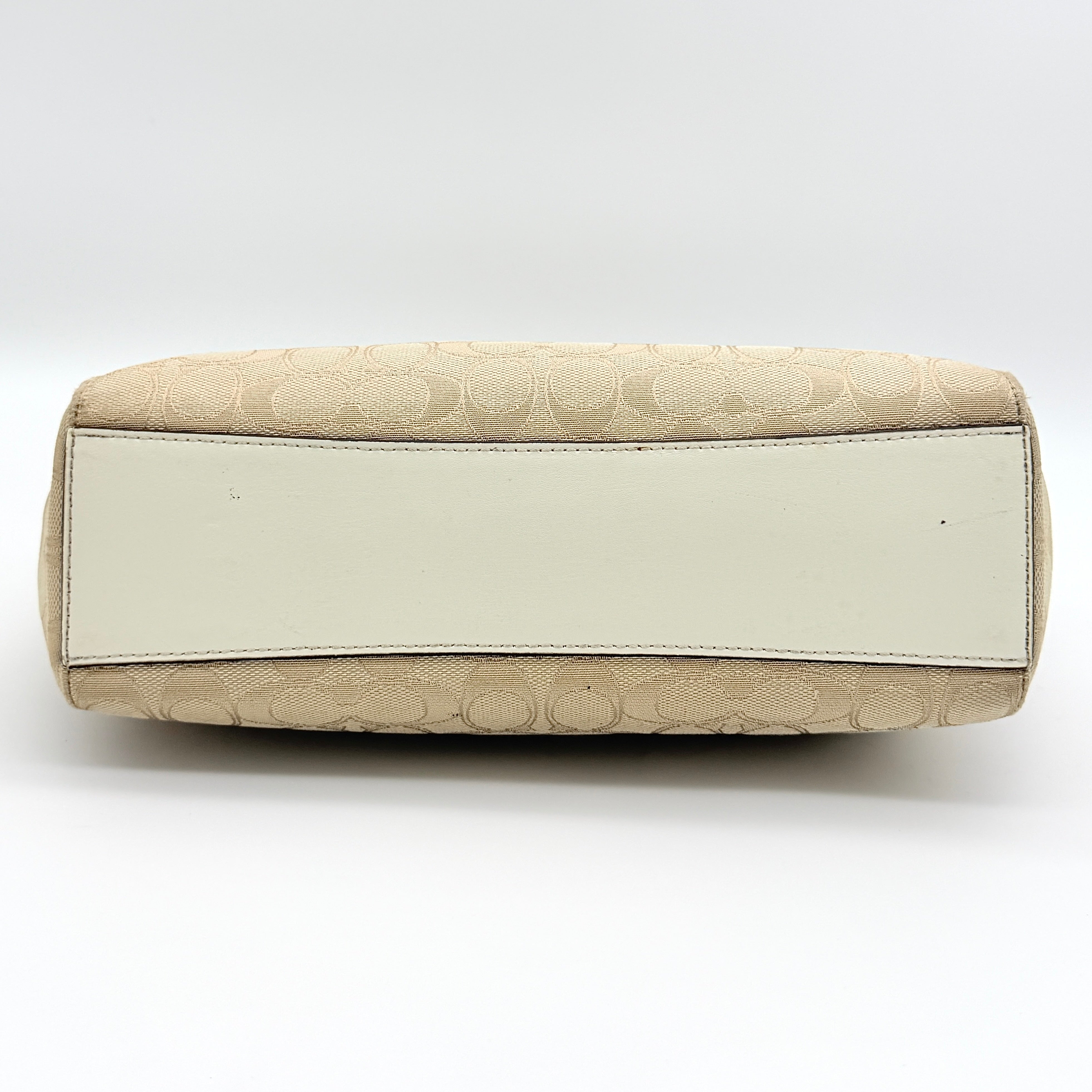 Coach Kelsey 2Way shoulder bag in beige signature canvas with cream leather handles and detachable strap, shown on a white background.