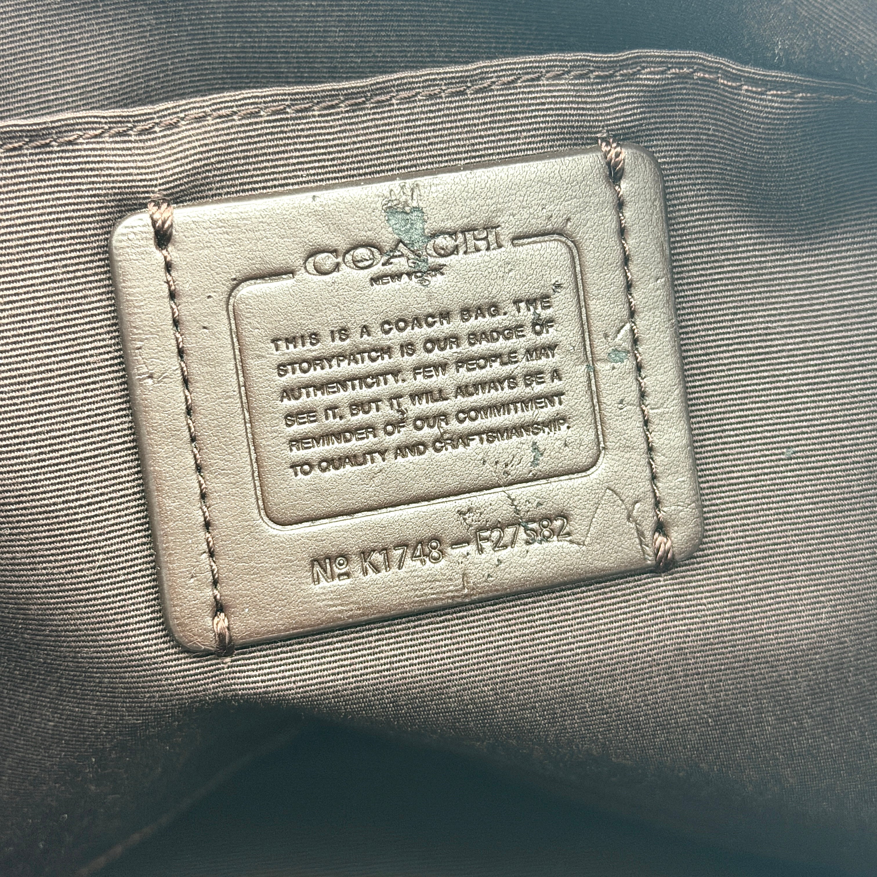 Coach Kelsey 2Way shoulder bag in beige signature canvas with cream leather handles and detachable strap, shown on a white background.