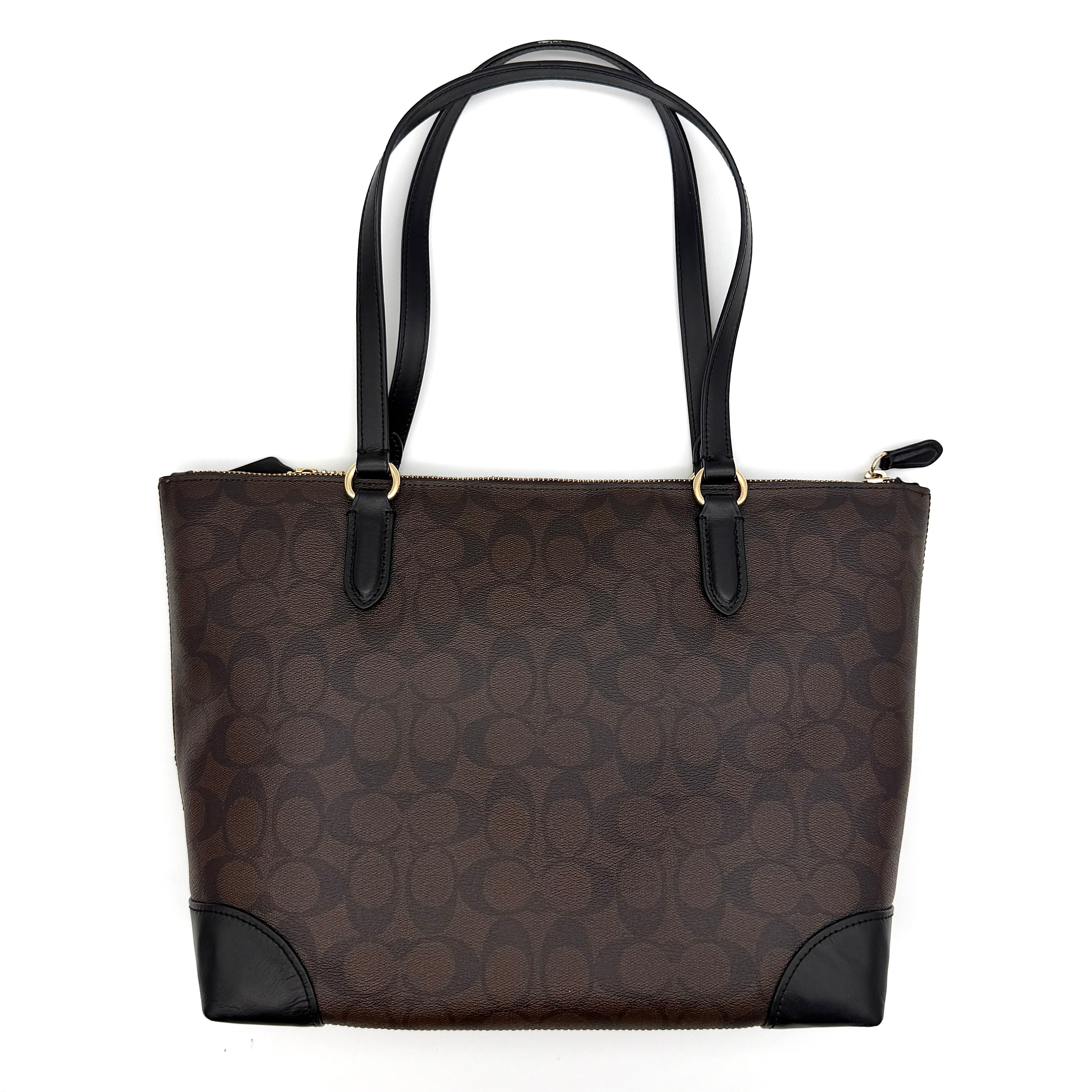 Coach Signature Zip Top Tote Bag in brown and black canvas with leather trim and gold-tone hardware.