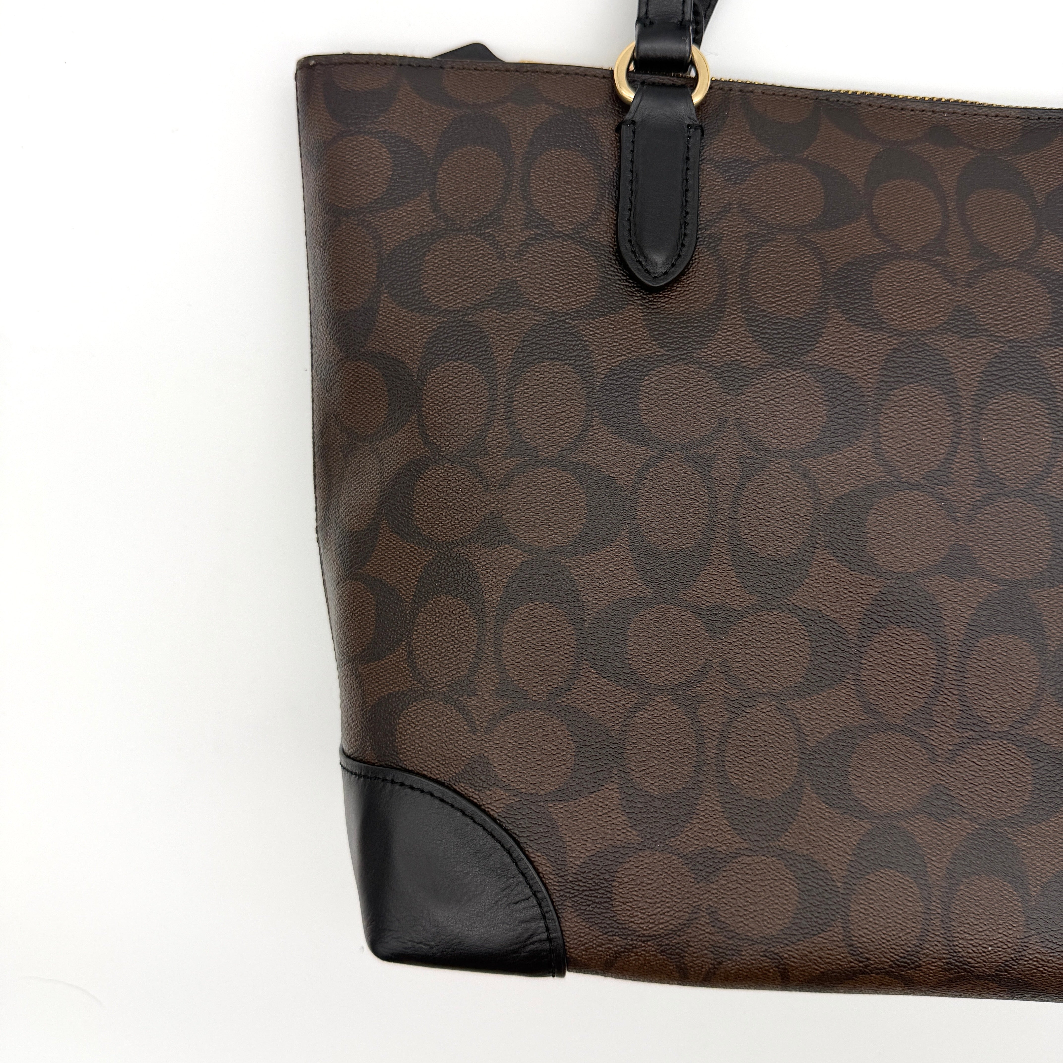 Coach Signature Zip Top Tote Bag in brown and black canvas with leather trim and gold-tone hardware.
