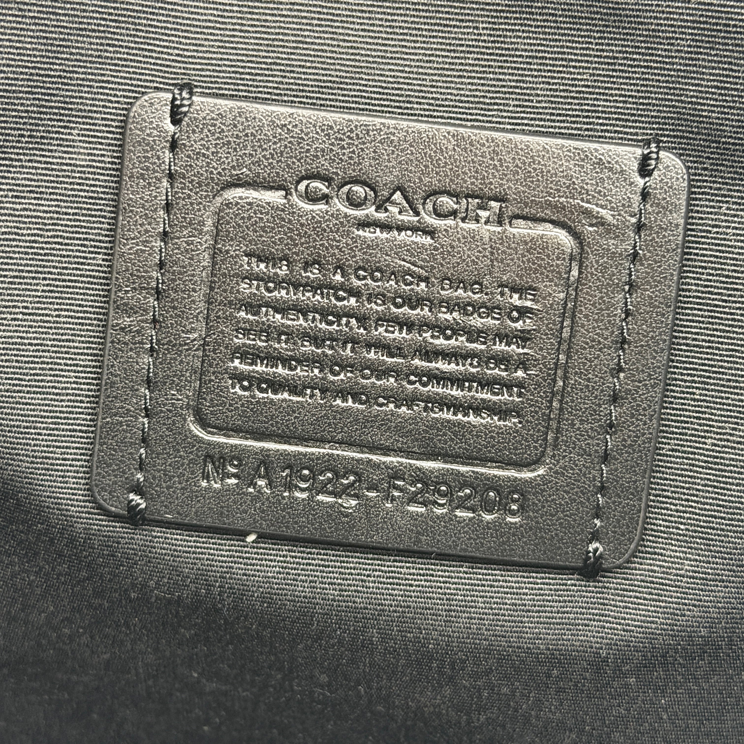 Coach Signature Zip Top Tote Bag in brown and black canvas with leather trim and gold-tone hardware.