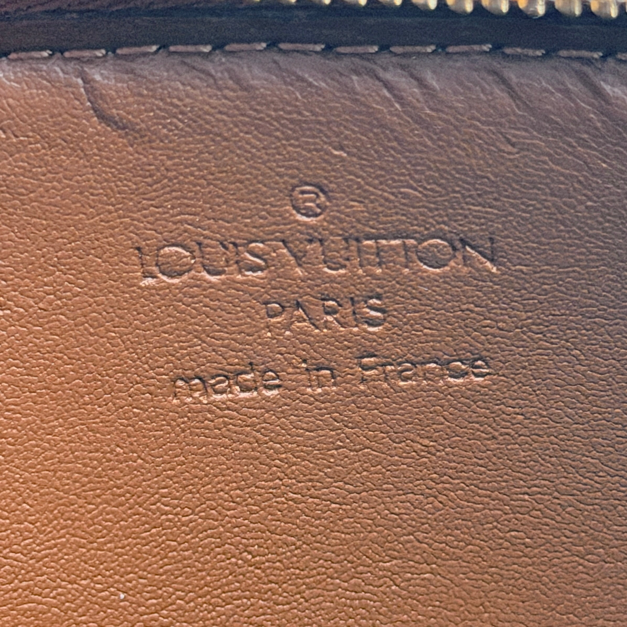 Louis Vuitton Monogram Lexington Vernis Pochette in bronze patent leather, shown with its gold-tone hardware and monogram embossing.