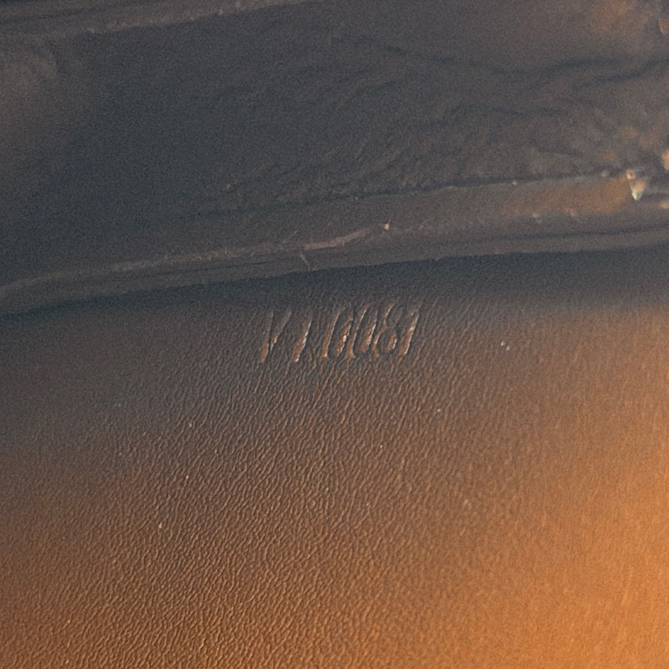 Louis Vuitton Monogram Lexington Vernis Pochette in bronze patent leather, shown with its gold-tone hardware and monogram embossing.