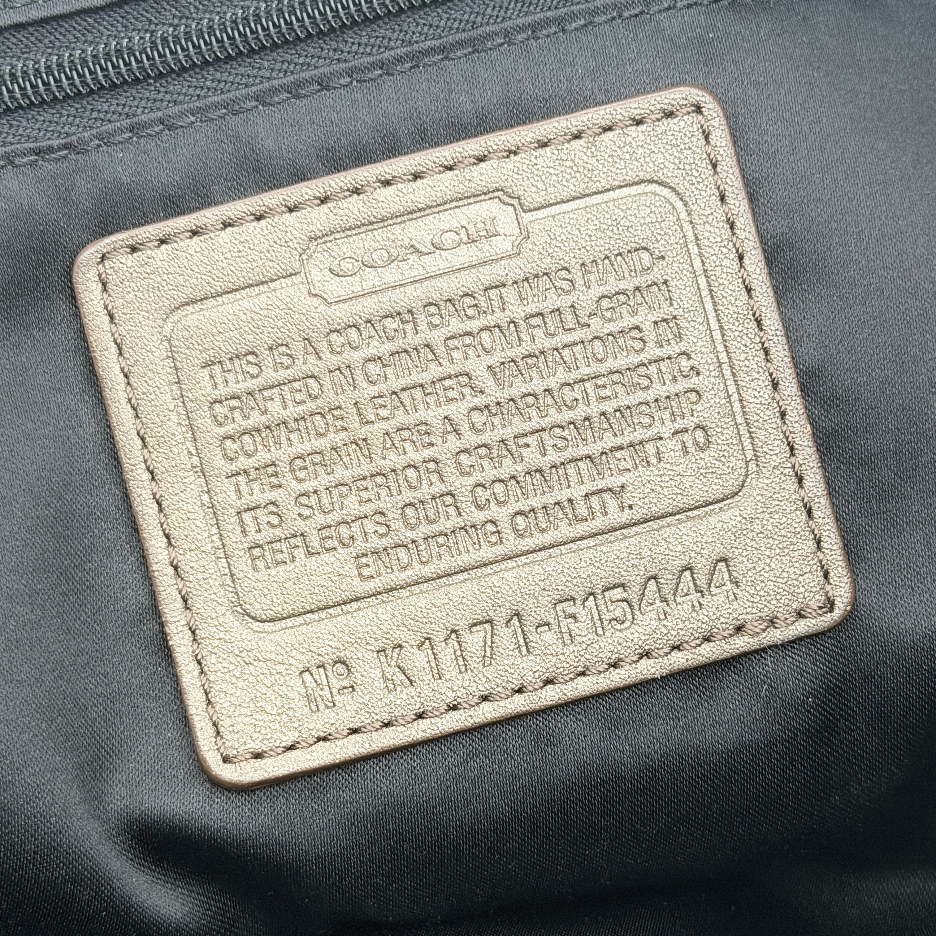 Coach Ashley 2Way shoulder bag in grey leather with gold-tone hardware and detachable strap, displayed against a white background.