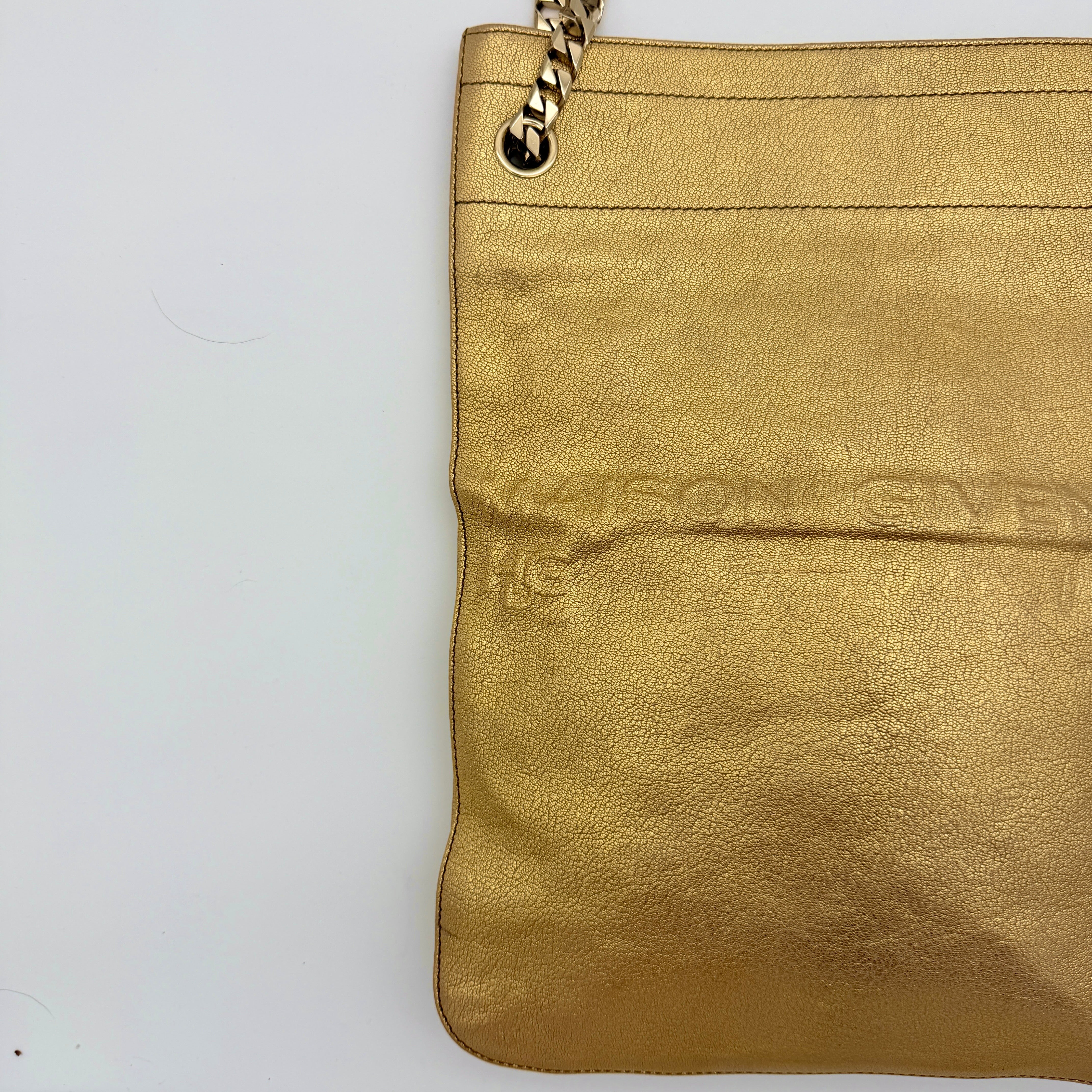Givenchy metallic gold chain shoulder bag with gold-tone chain straps and embossed logo, displayed on a dust bag.