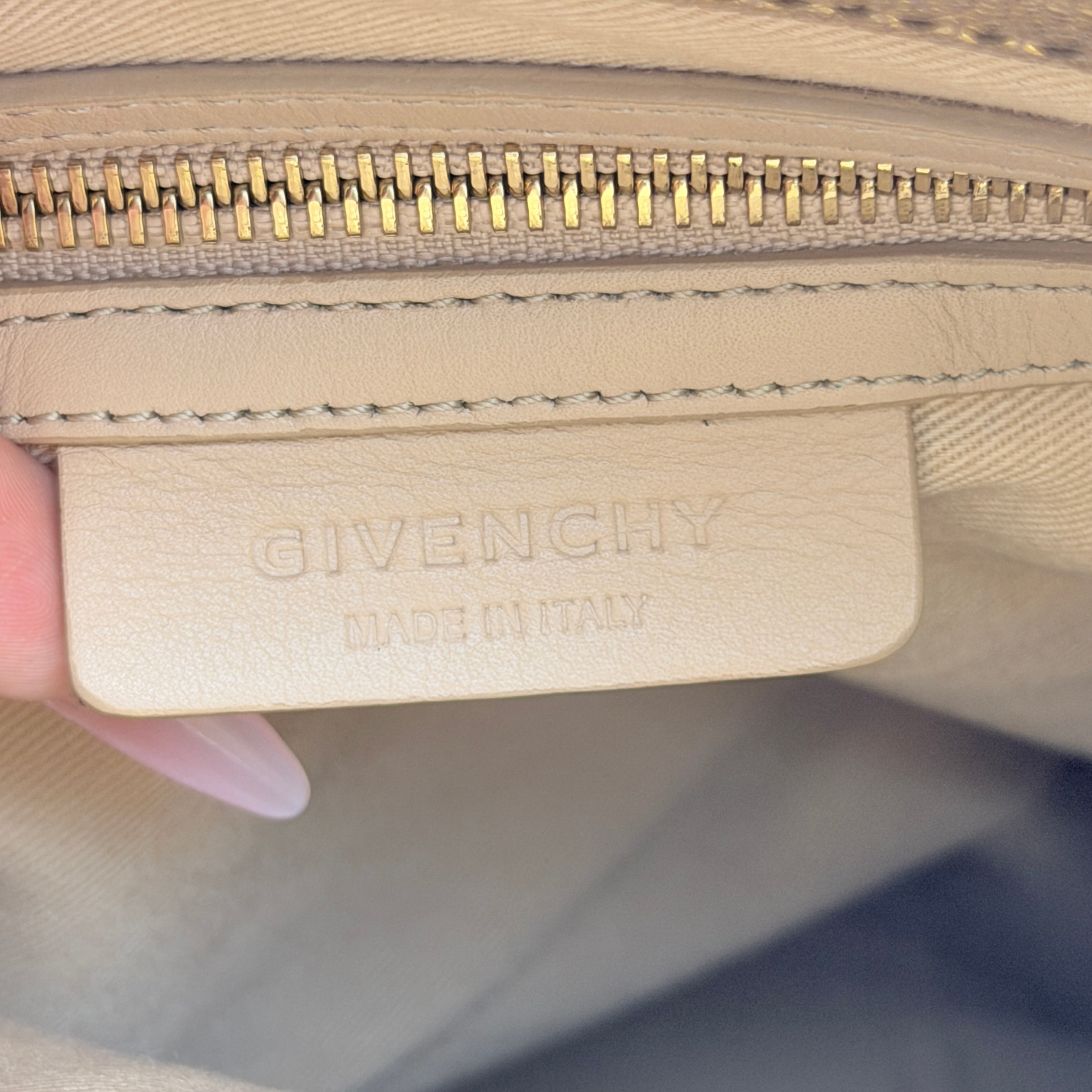 Givenchy metallic gold chain shoulder bag with gold-tone chain straps and embossed logo, displayed on a dust bag.