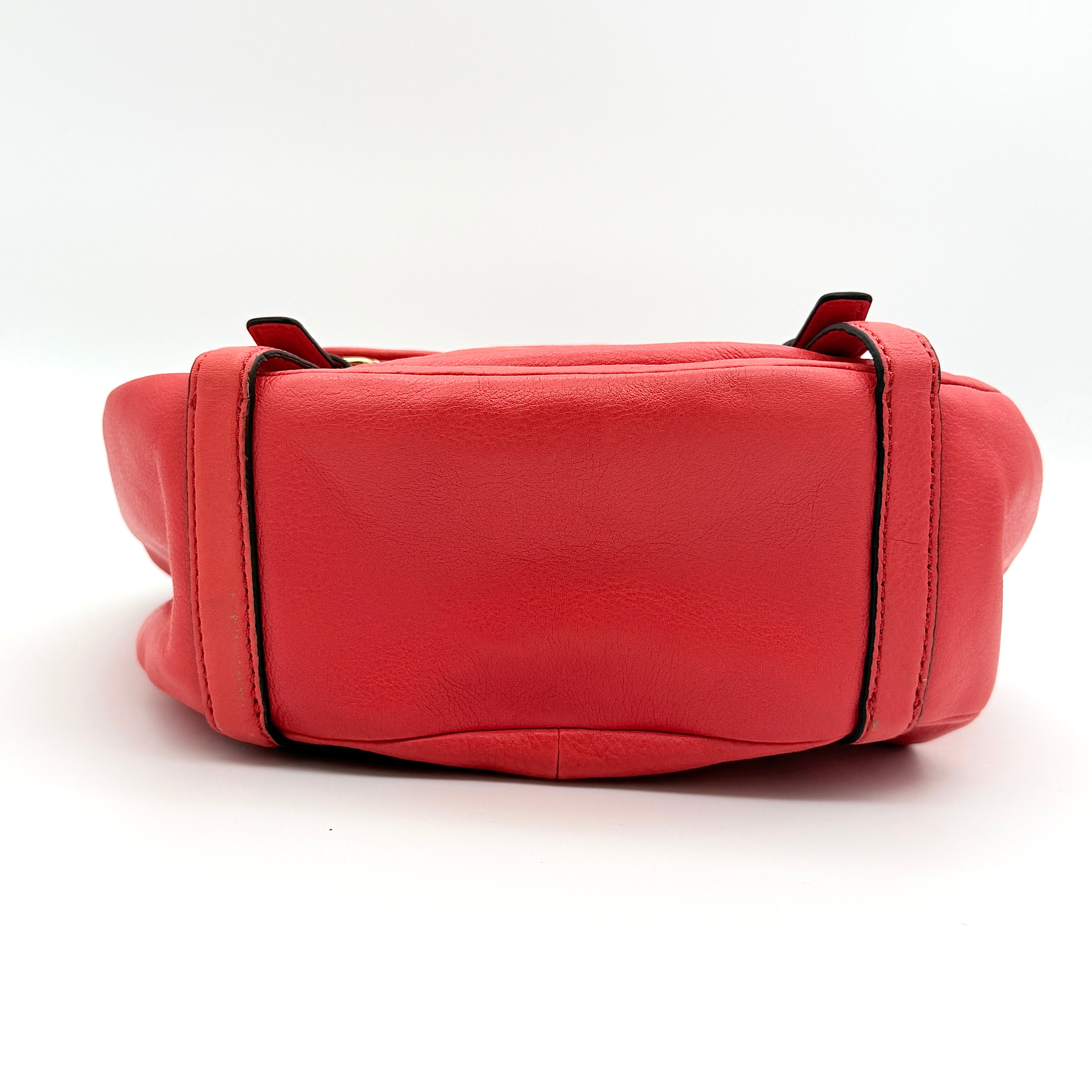 Coach Madison Anabelle red leather handbag with gold tone hardware, top handle, and detachable strap displayed on a white background