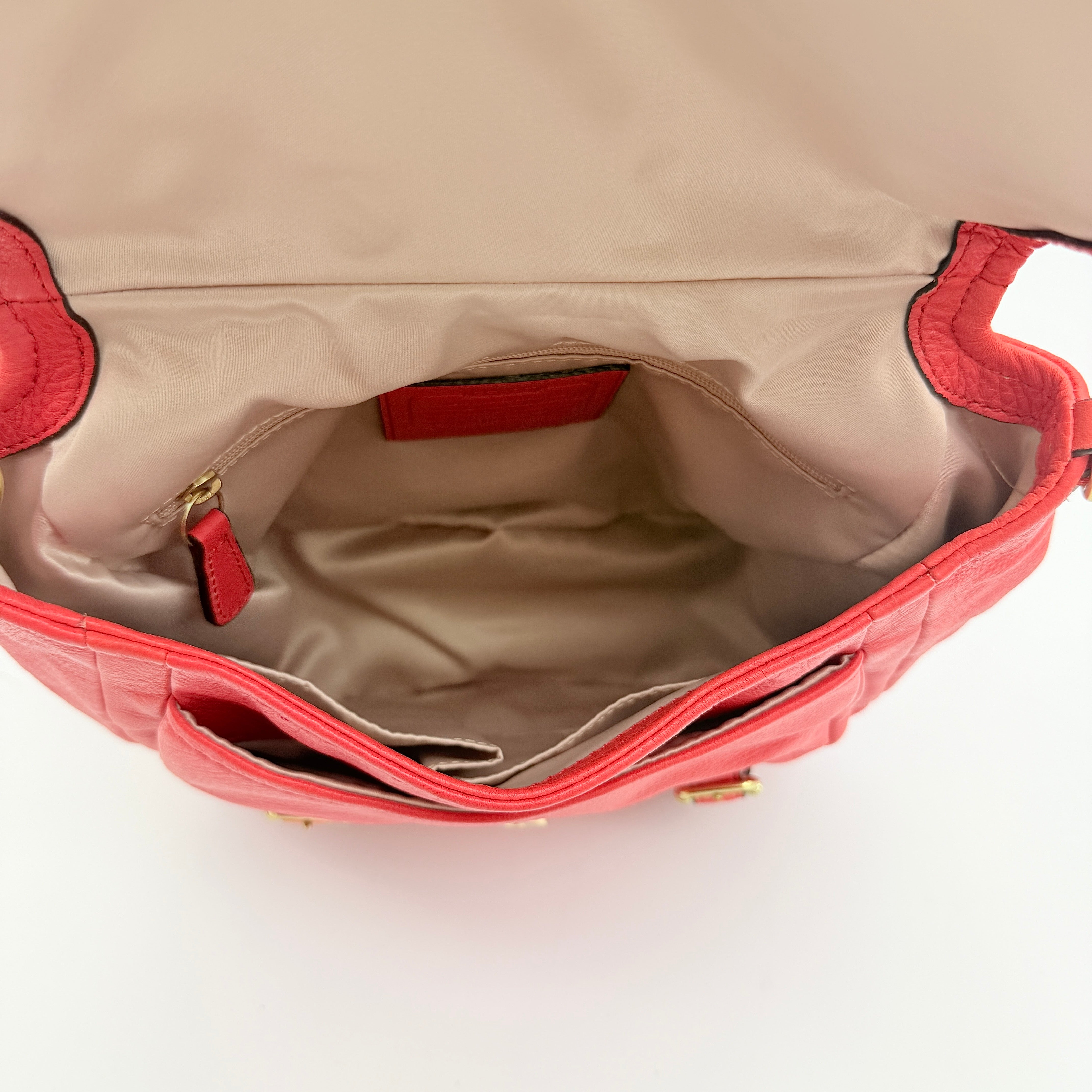 Coach Madison Anabelle red leather handbag with gold tone hardware, top handle, and detachable strap displayed on a white background