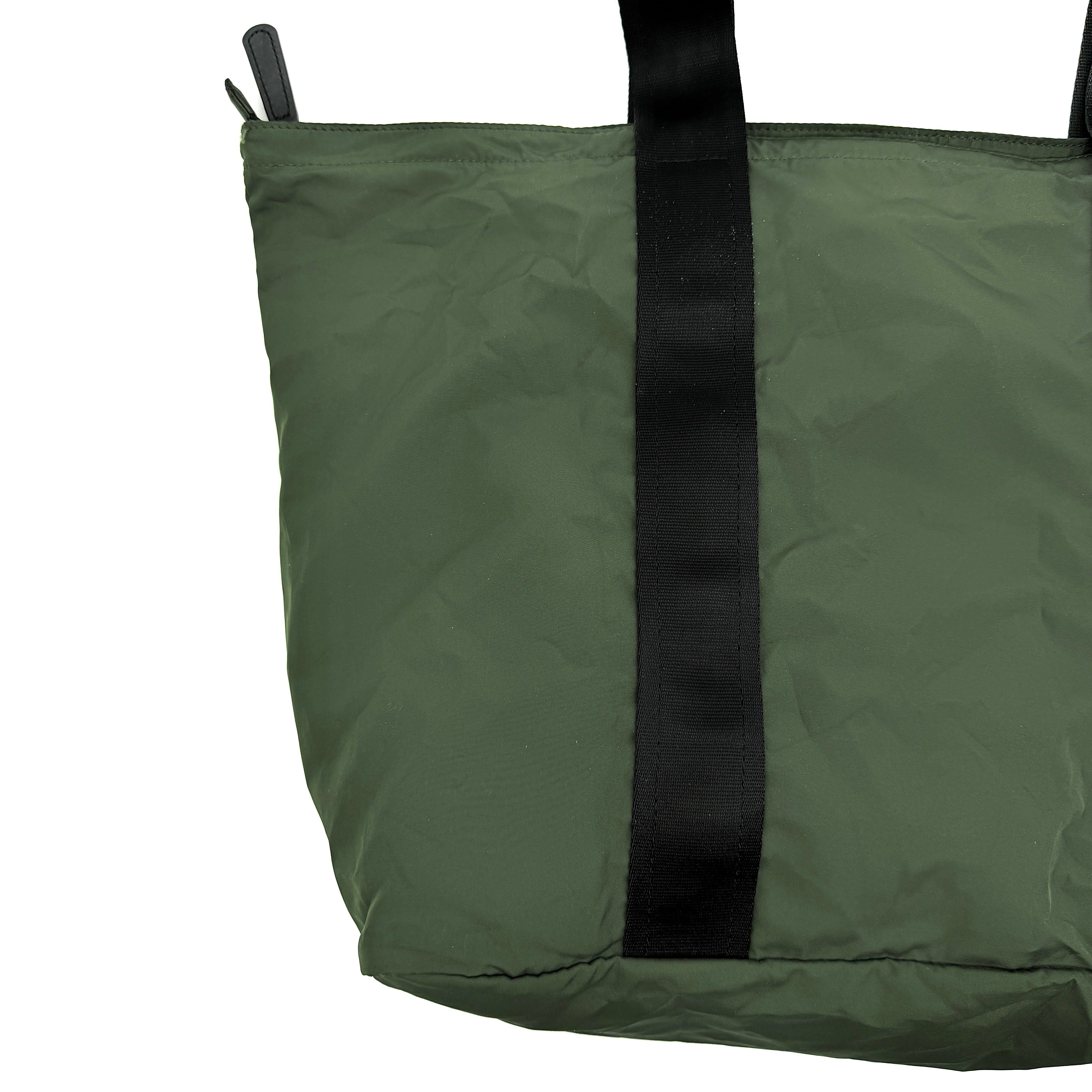 Coach Varick Packable Weekend Tote in green nylon with black web straps and a zippered external pocket.
