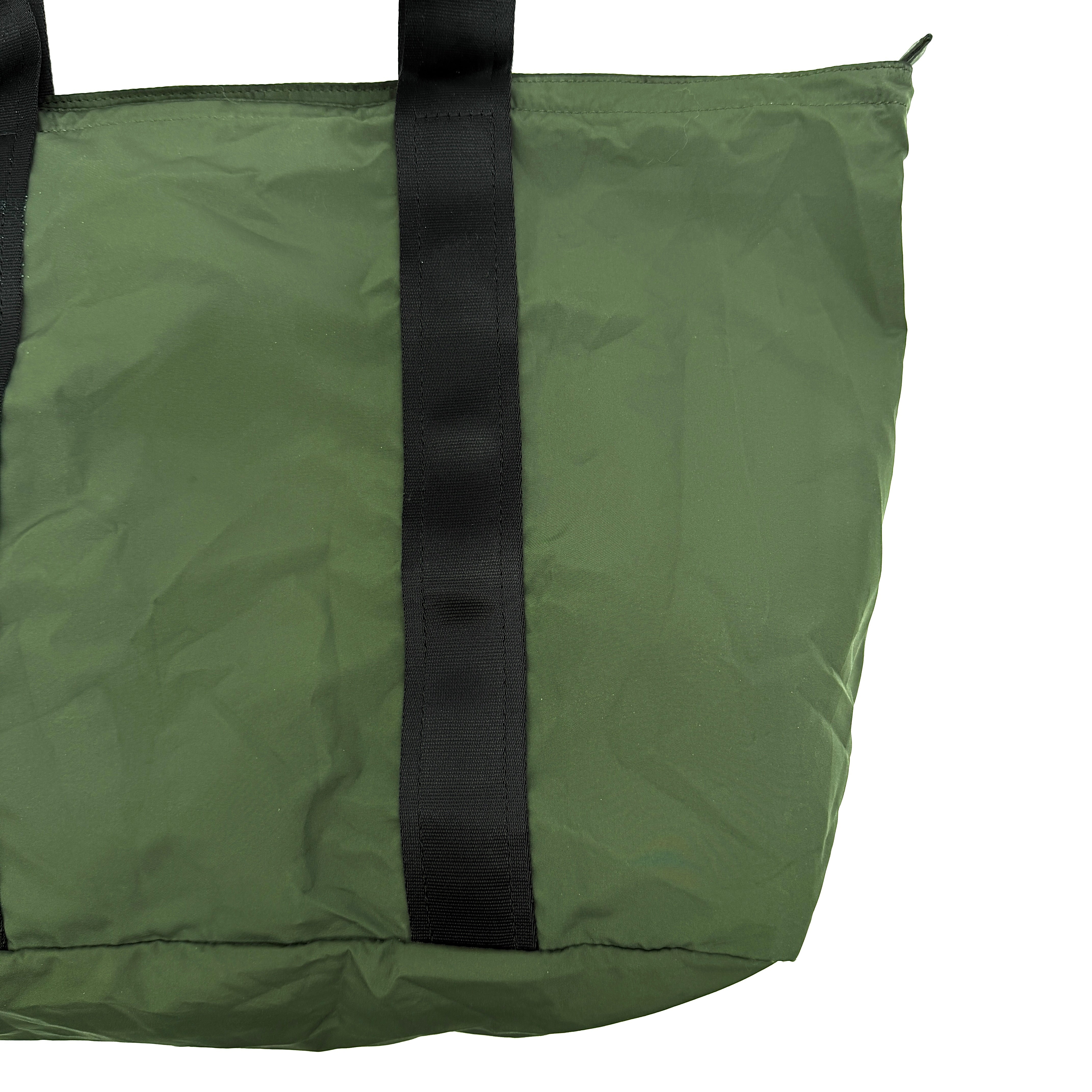 Coach Varick Packable Weekend Tote in green nylon with black web straps and a zippered external pocket.