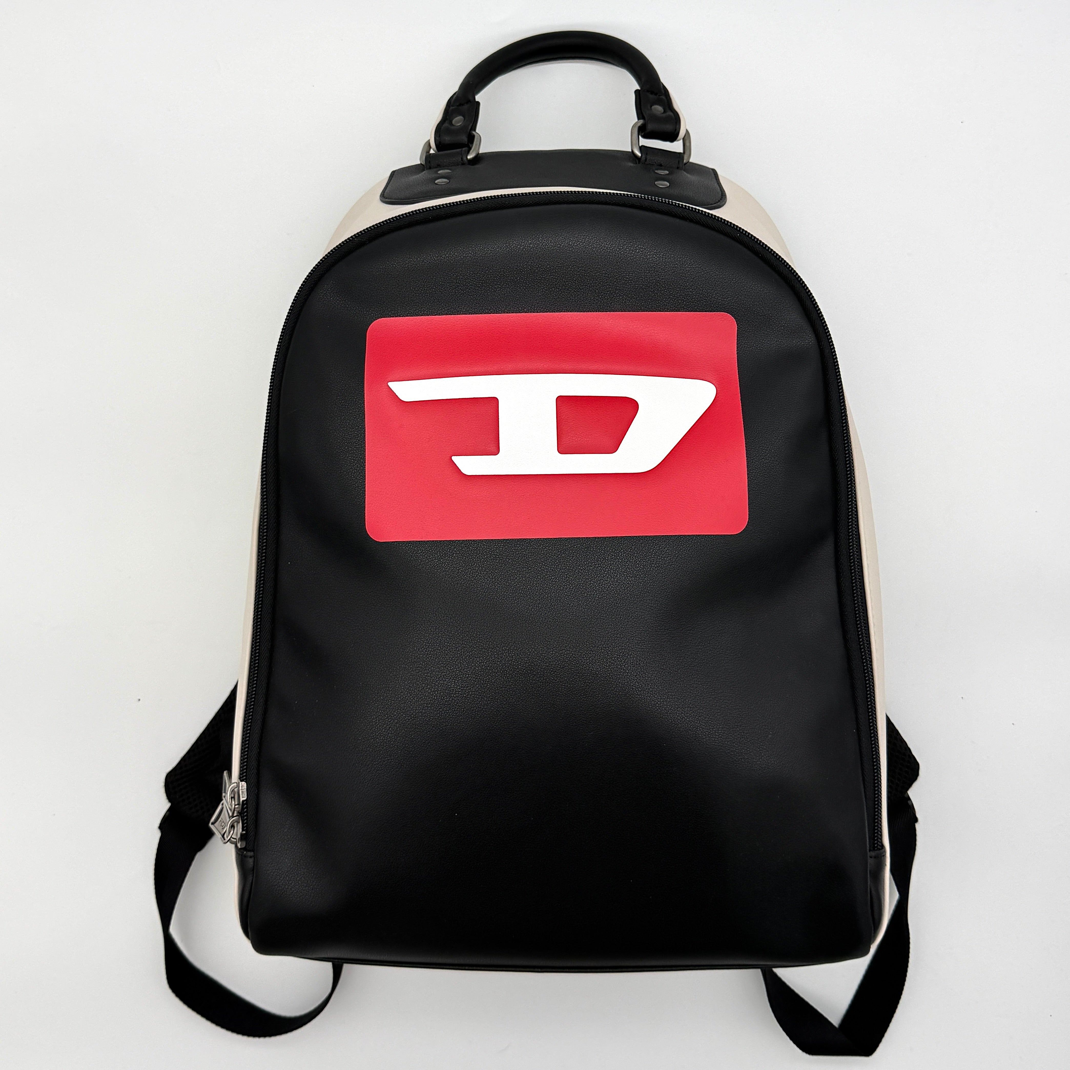 Diesel D-Logo Colorblock Backpack in black and white faux leather with a red logo patch and silver-tone hardware.