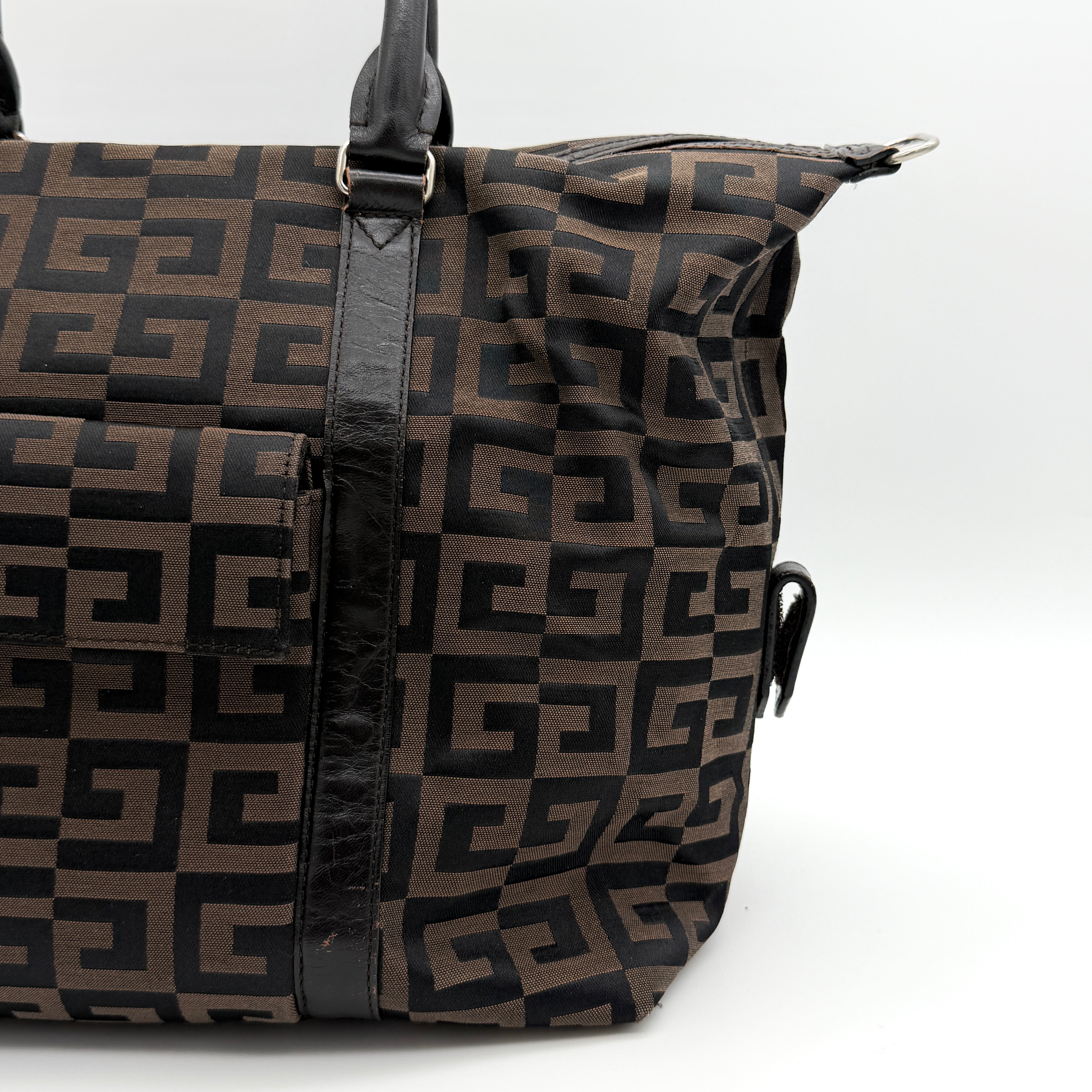 Givenchy 4G Monogram Handbag in brown and black fabric with leather handles and bold graphic pattern.