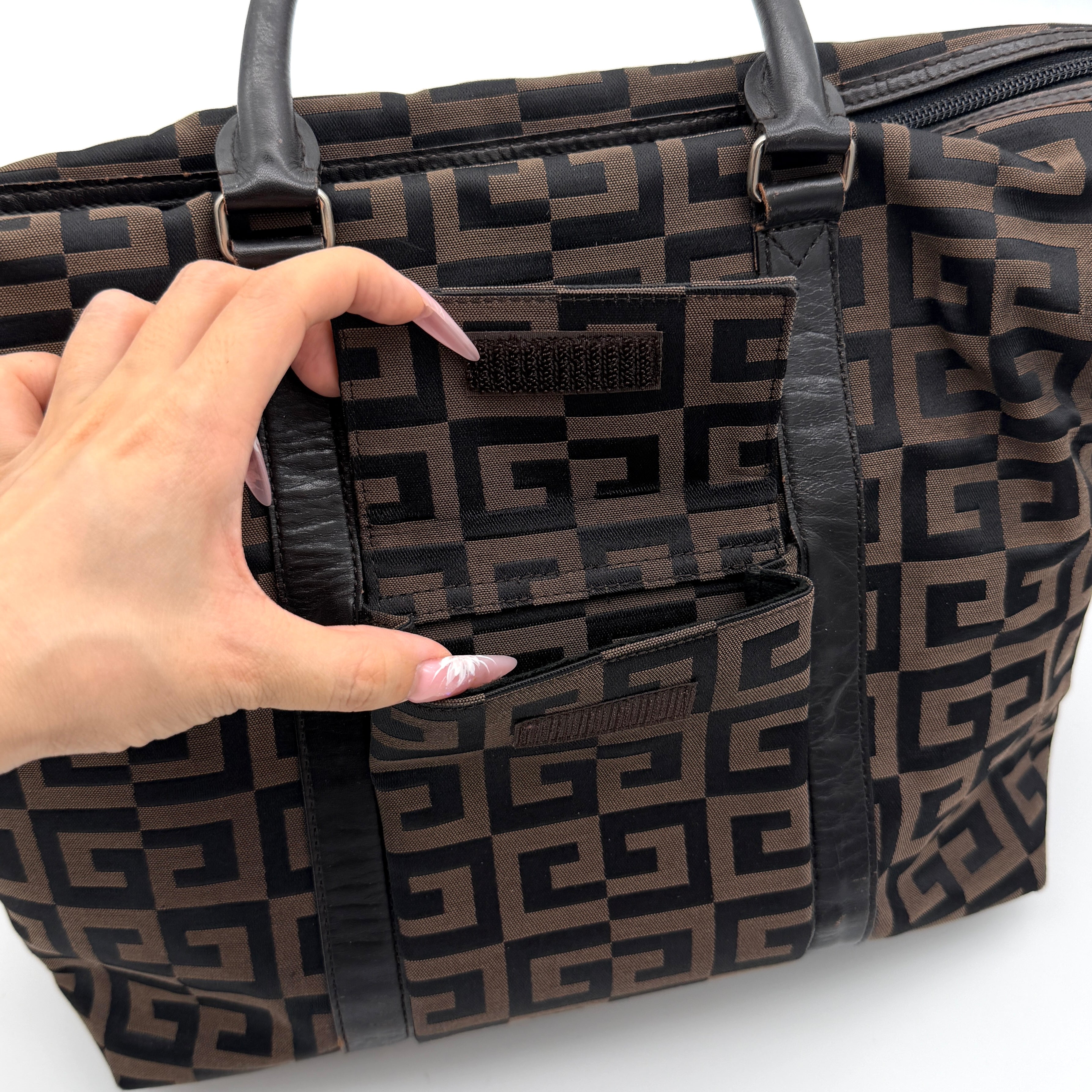 Givenchy 4G Monogram Handbag in brown and black fabric with leather handles and bold graphic pattern.