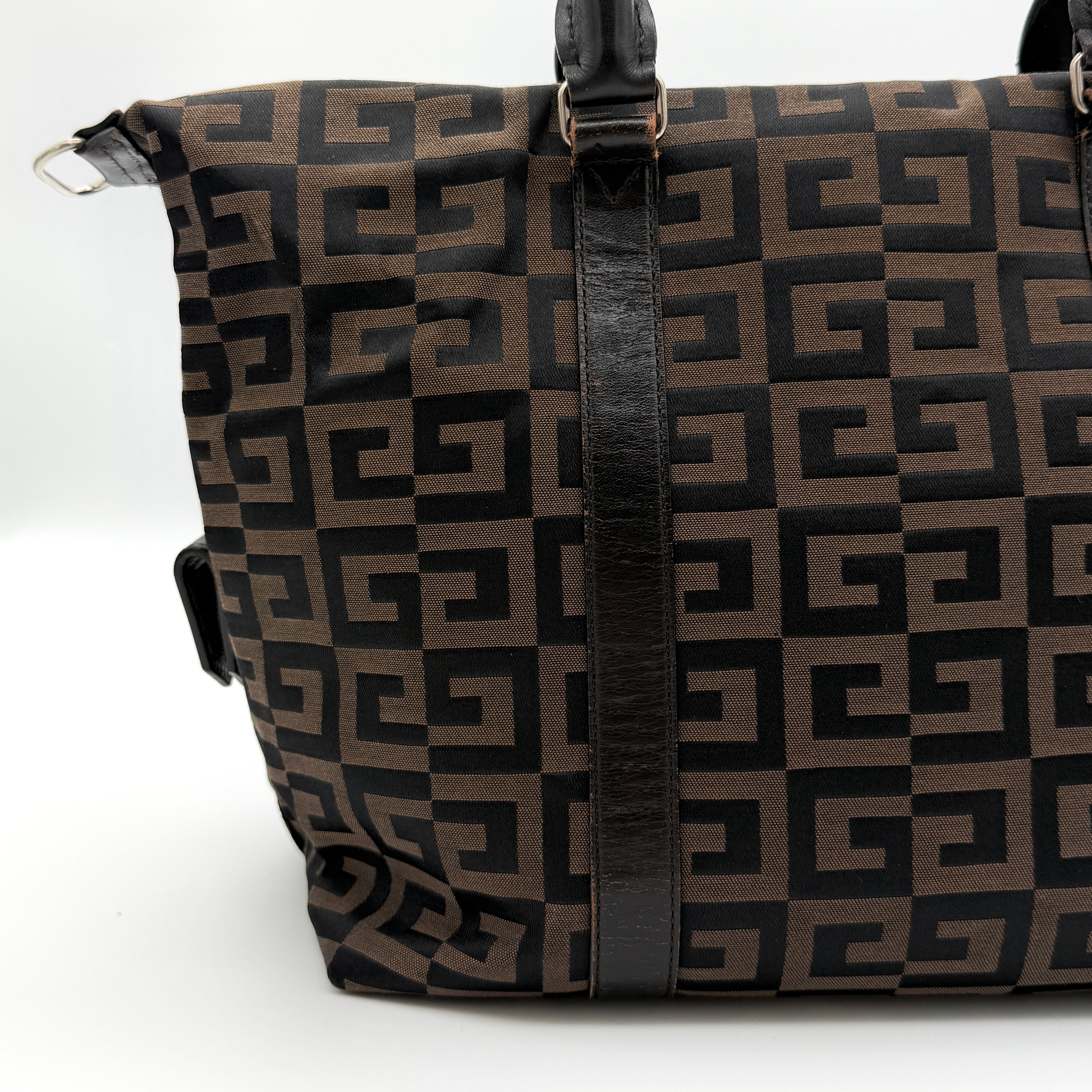Givenchy 4G Monogram Handbag in brown and black fabric with leather handles and bold graphic pattern.