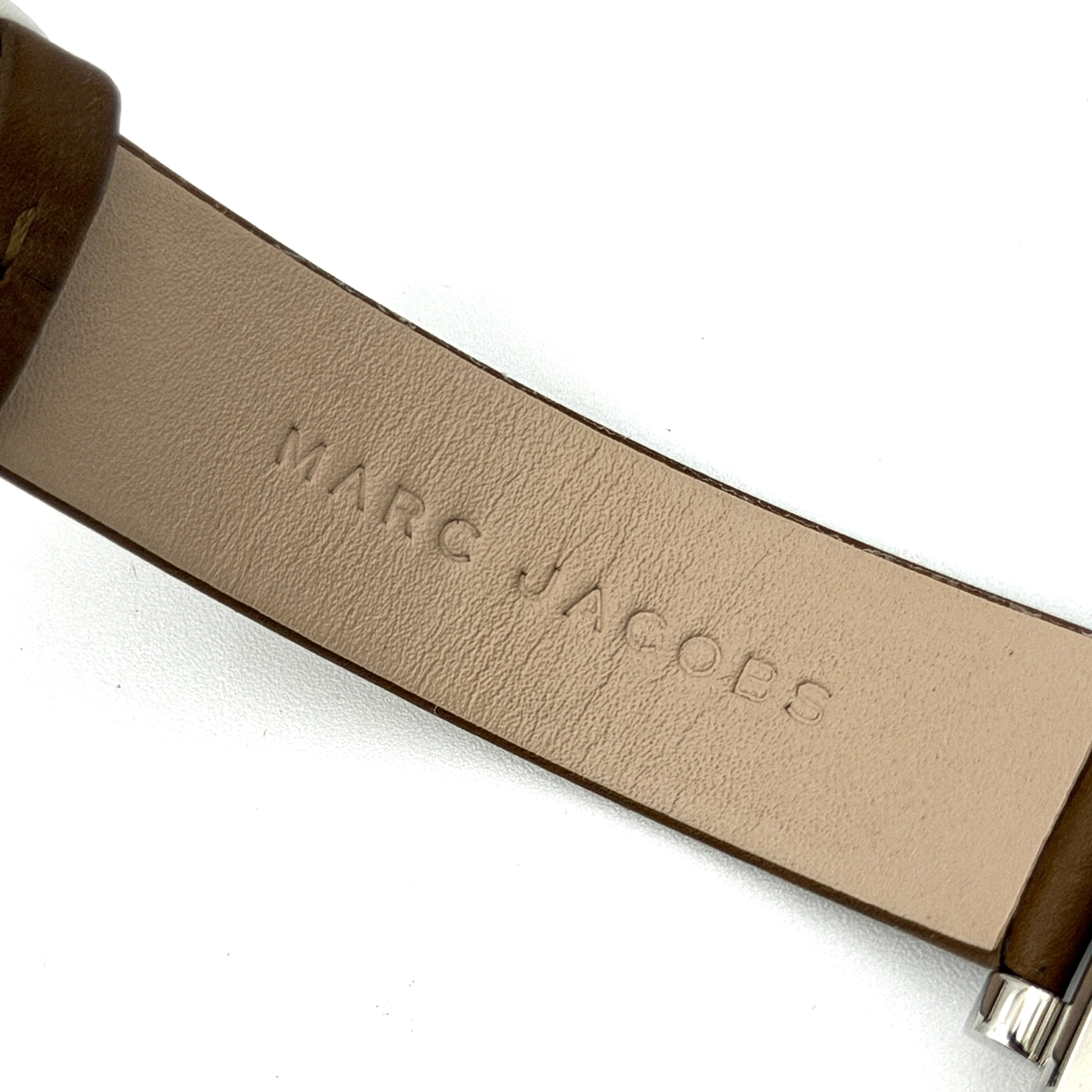 Marc Jacobs MJ1436 silver square watch with brown leather strap displayed on a branded watch cushion.