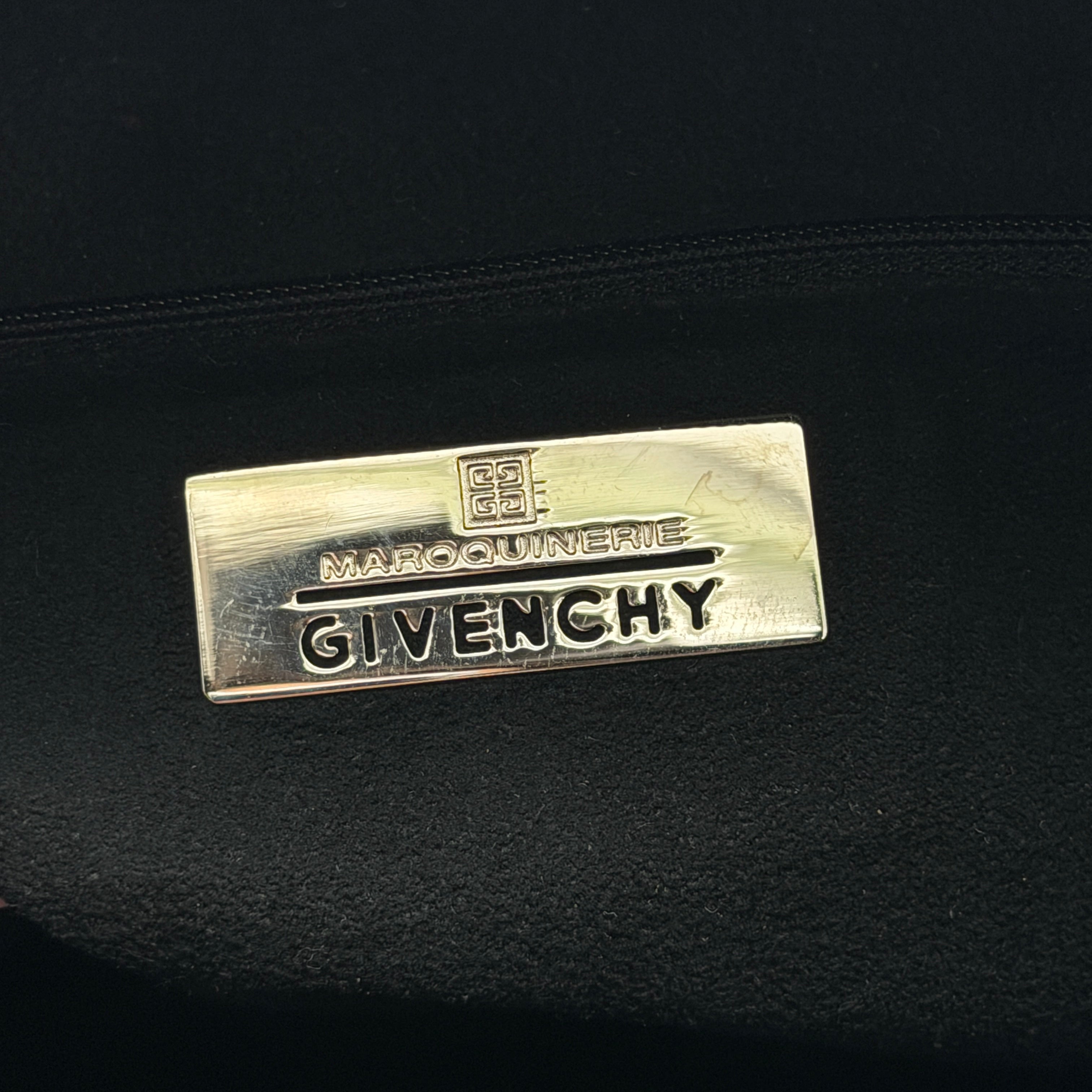 Givenchy 4G Monogram Handbag in brown and black fabric with leather handles and bold graphic pattern.