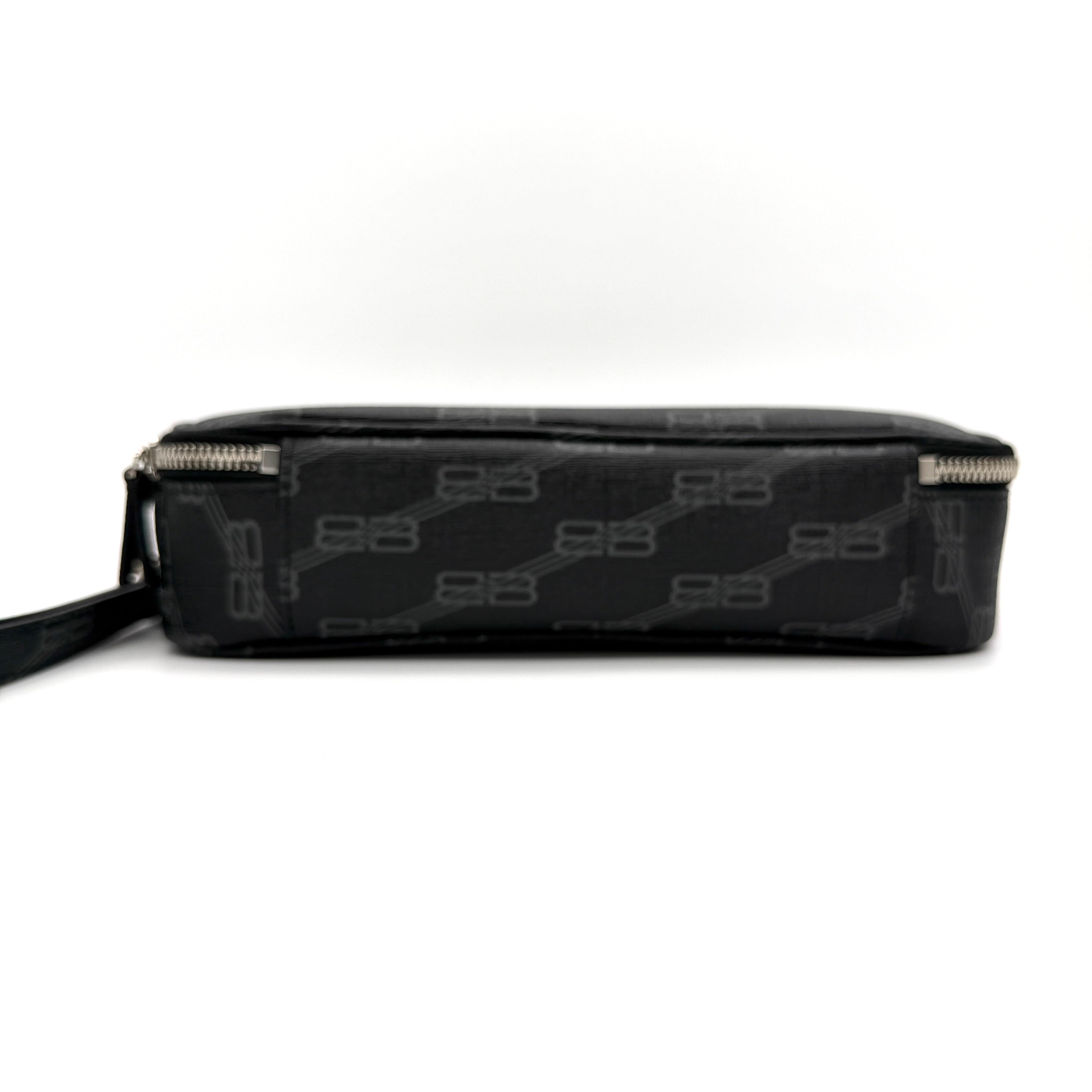 Balenciaga Signature BB Monogram Everyday Clutch Bag in black with double zip compartments and detachable wrist strap displayed on a Balenciaga dust bag.