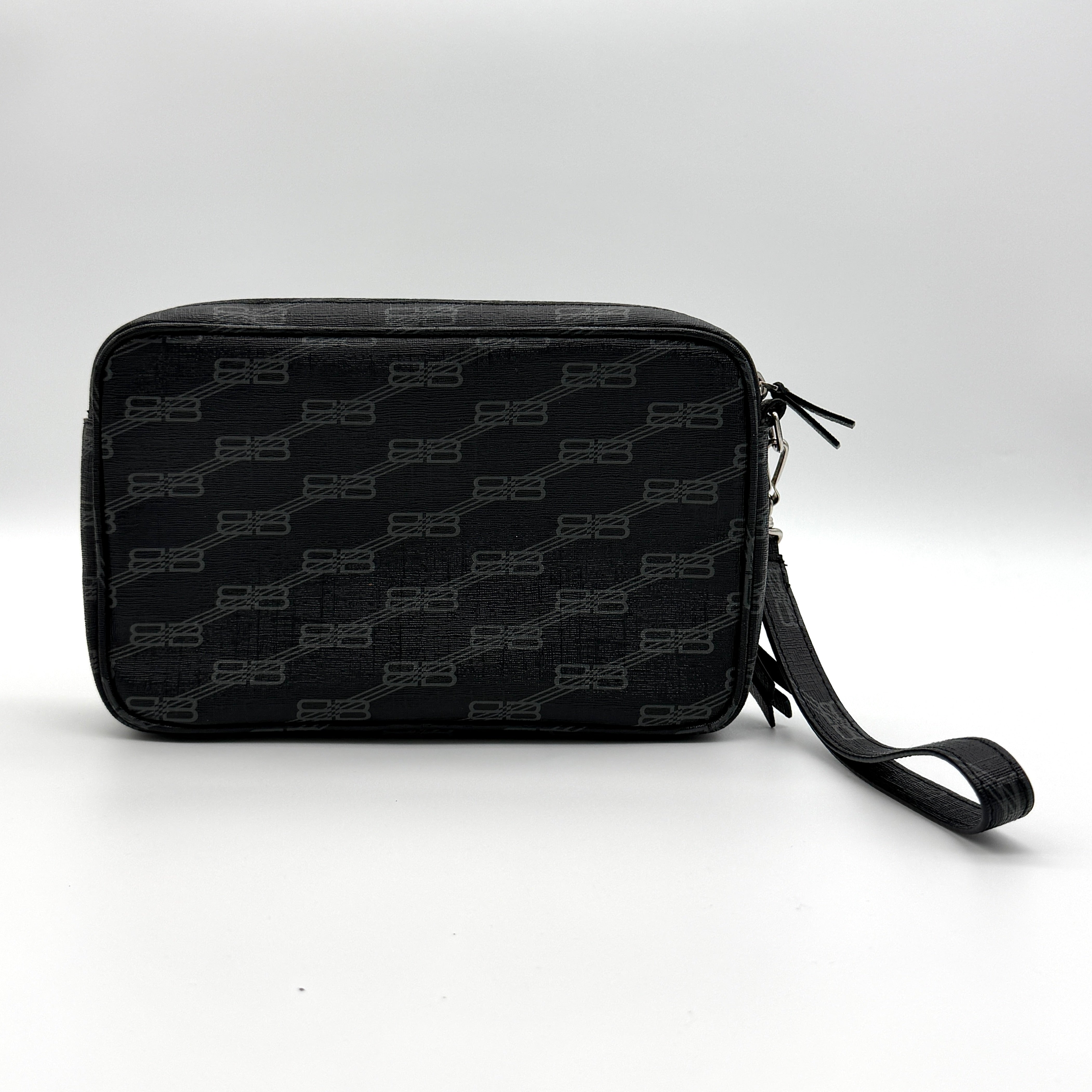 Balenciaga Signature BB Monogram Everyday Clutch Bag in black with double zip compartments and detachable wrist strap displayed on a Balenciaga dust bag.