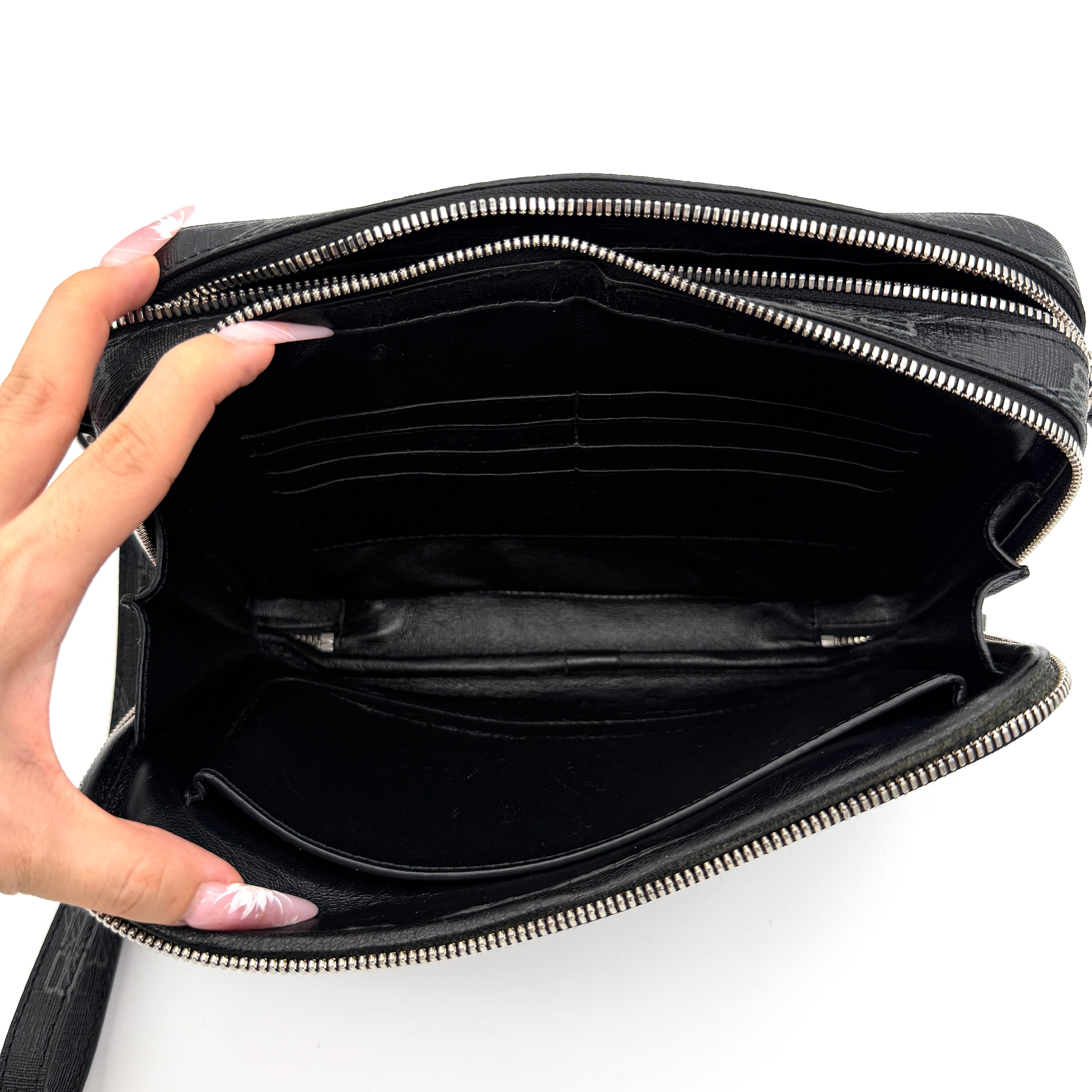 Balenciaga Signature BB Monogram Everyday Clutch Bag in black with double zip compartments and detachable wrist strap displayed on a Balenciaga dust bag.