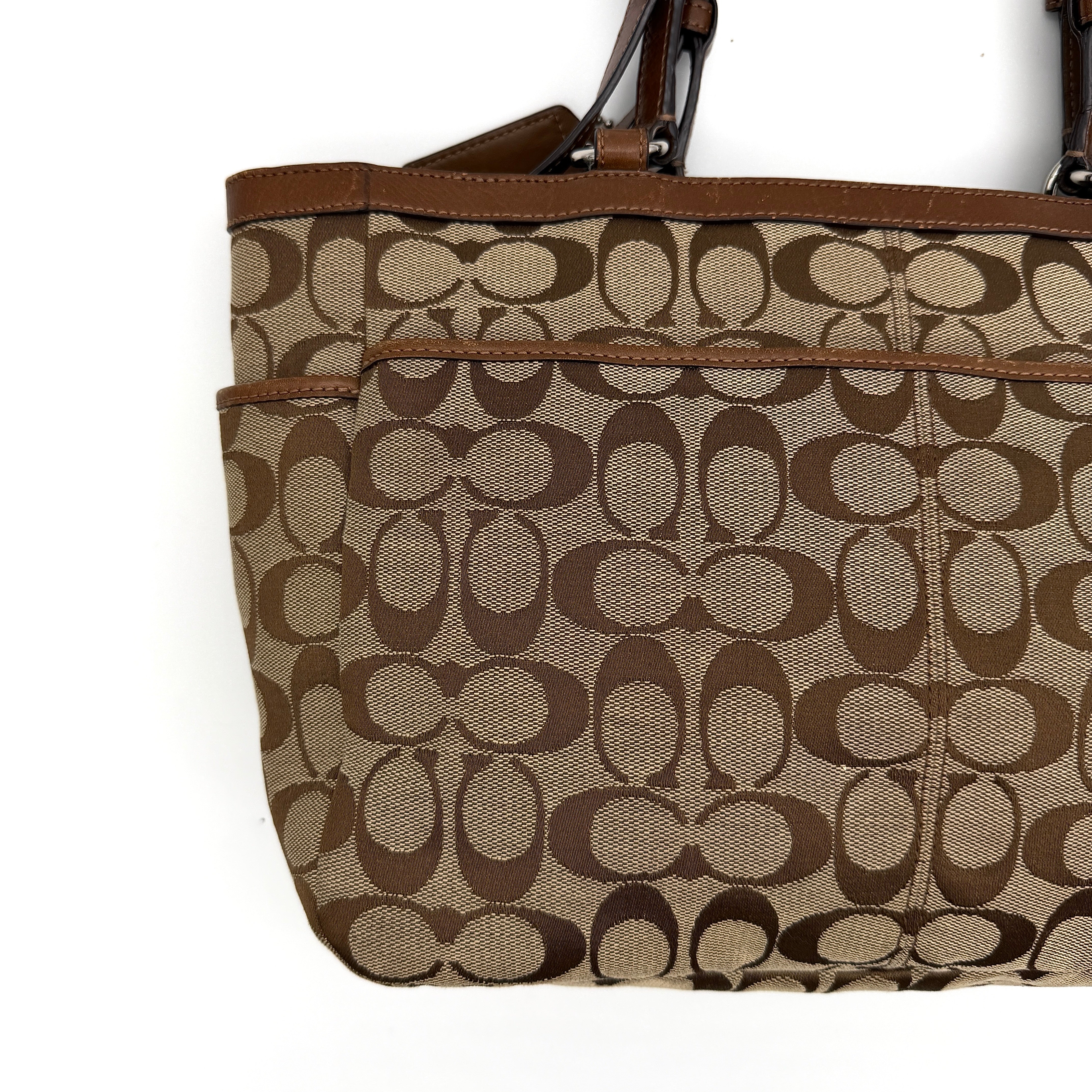 Coach Signature Gallery Tote Bag in beige and brown with double leather handles and the iconic logo pattern.