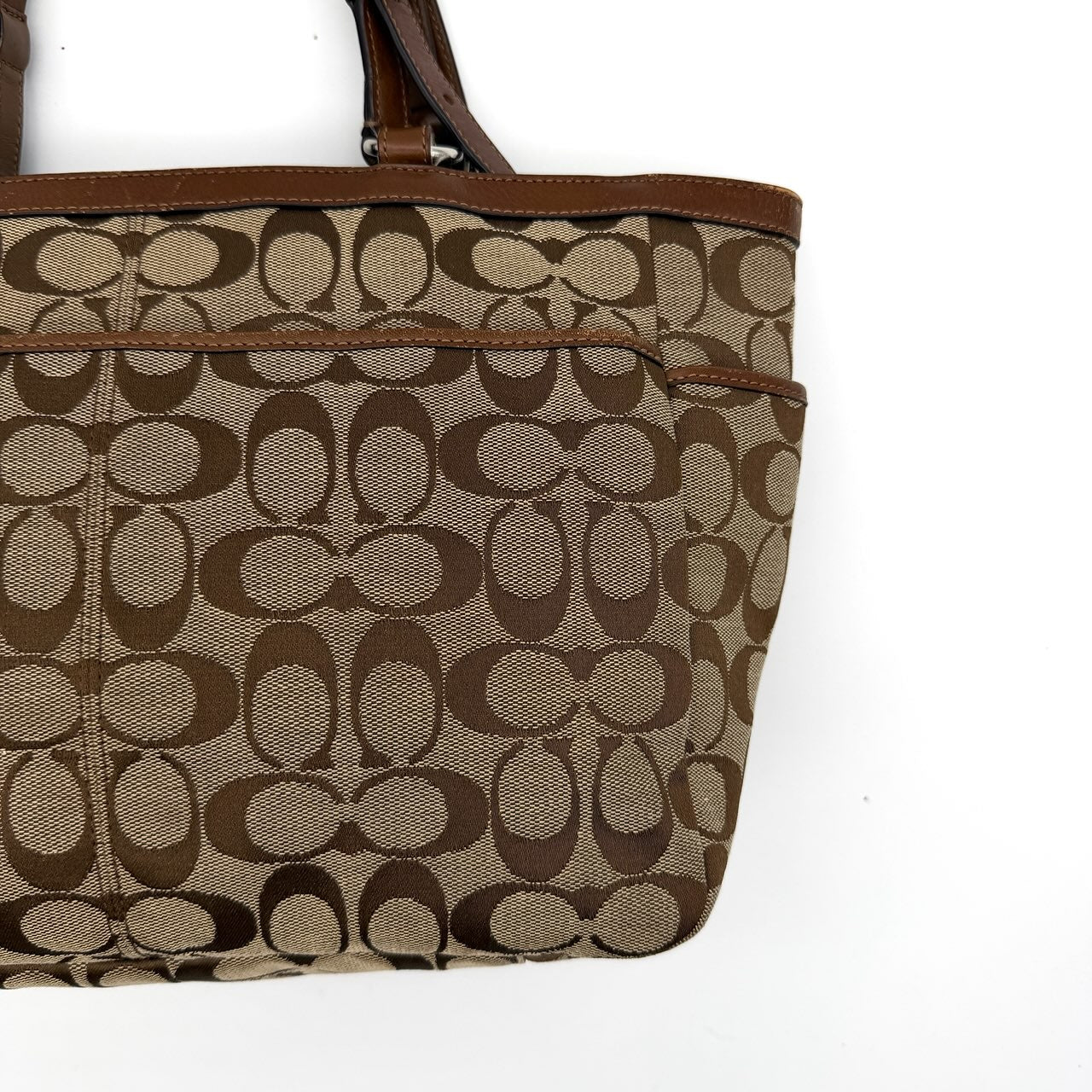Coach Signature Gallery Tote Bag in beige and brown with double leather handles and the iconic logo pattern.