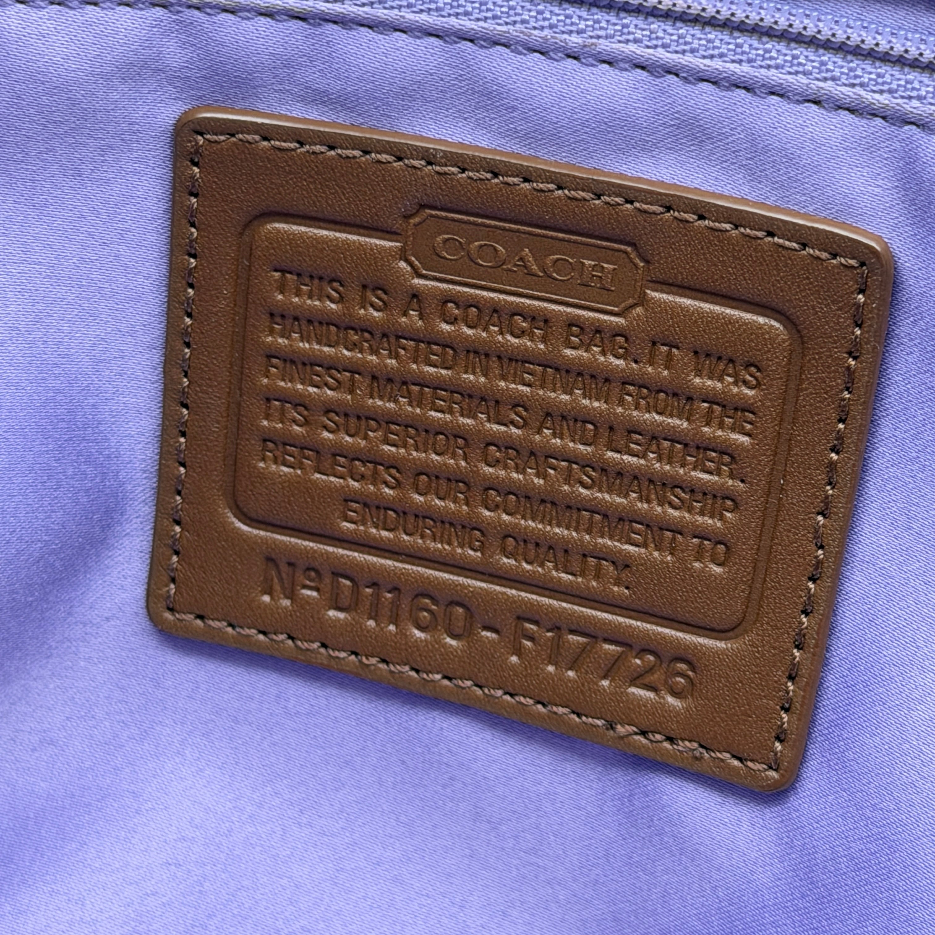 Coach Signature Gallery Tote Bag in beige and brown with double leather handles and the iconic logo pattern.