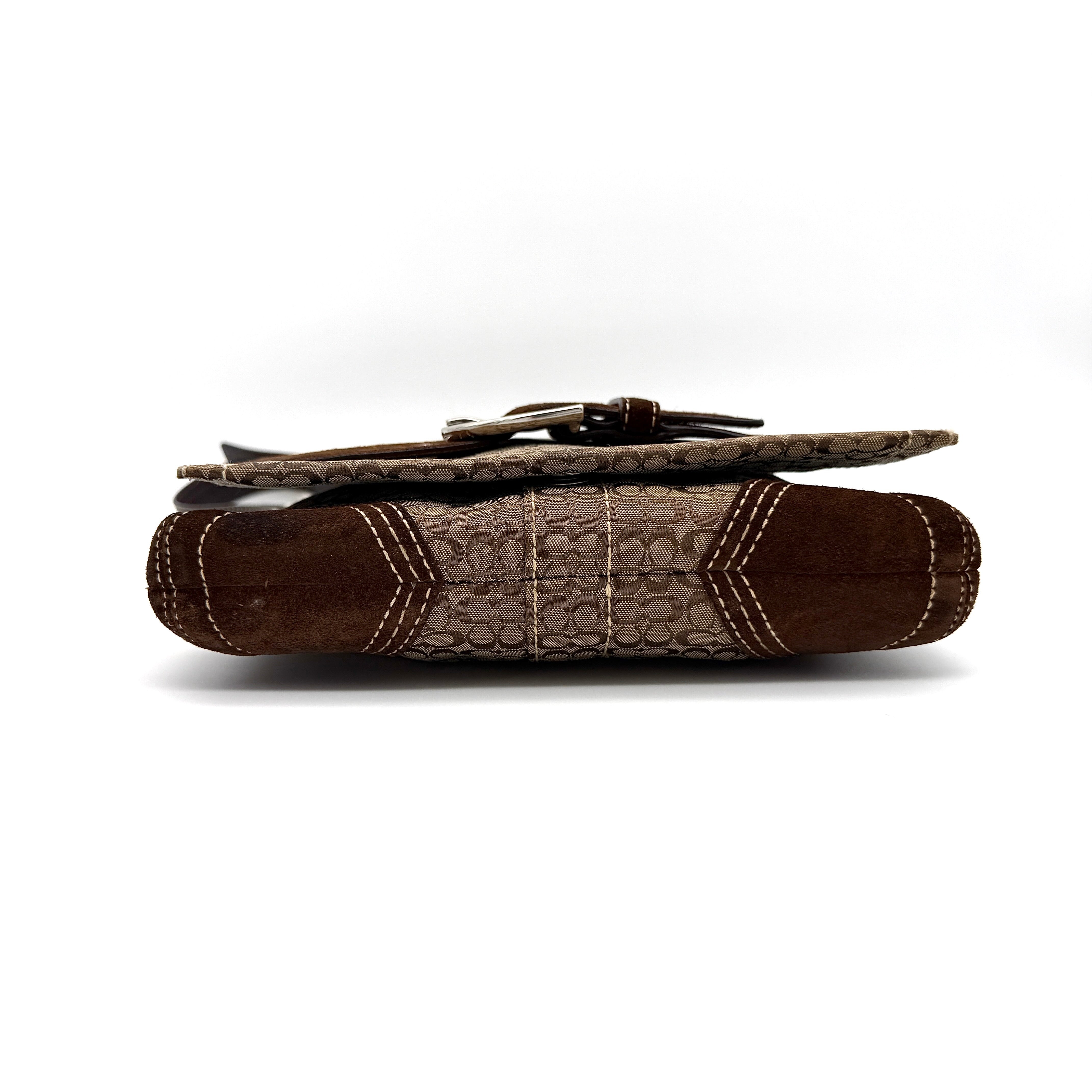 Coach Signature Soho Flap Crossbody Bag in brown jacquard canvas with suede trim and silver buckle, shown with adjustable strap.
