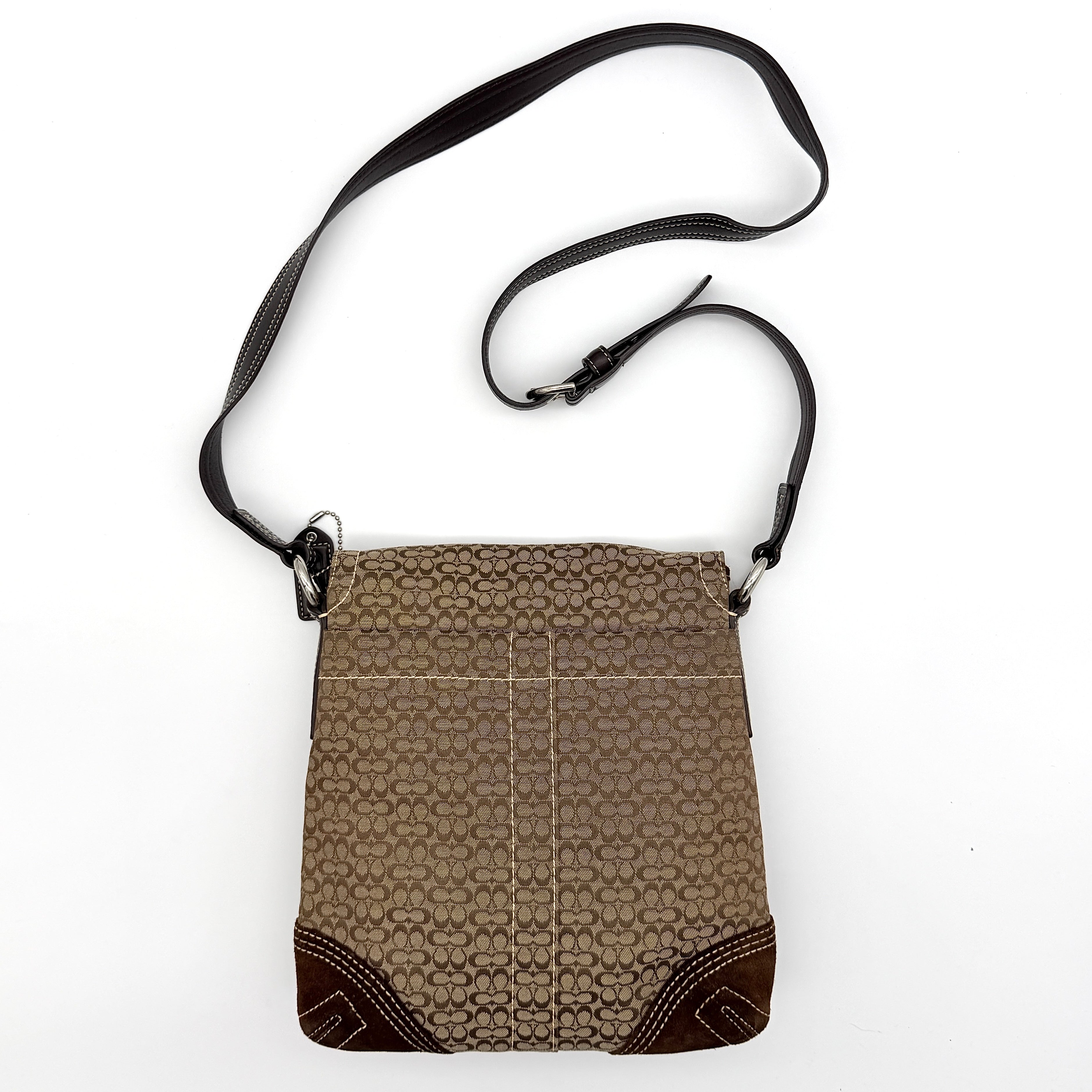 Coach Signature Soho Flap Crossbody Bag in brown jacquard canvas with suede trim and silver buckle, shown with adjustable strap.