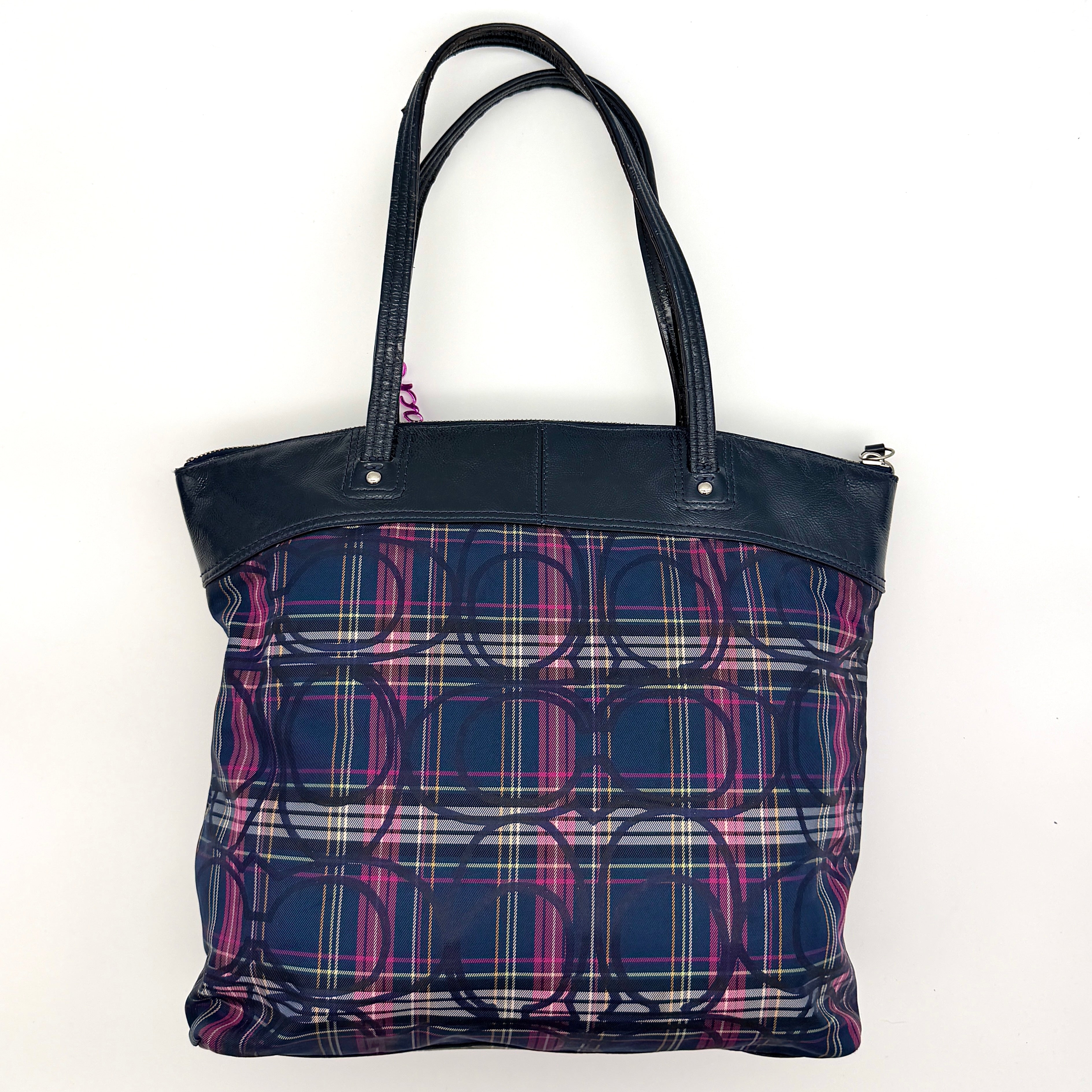 Coach Signature Tartan Plaid Tote Bag in navy, pink and yellow plaid with embossed leather circle and black leather trim.