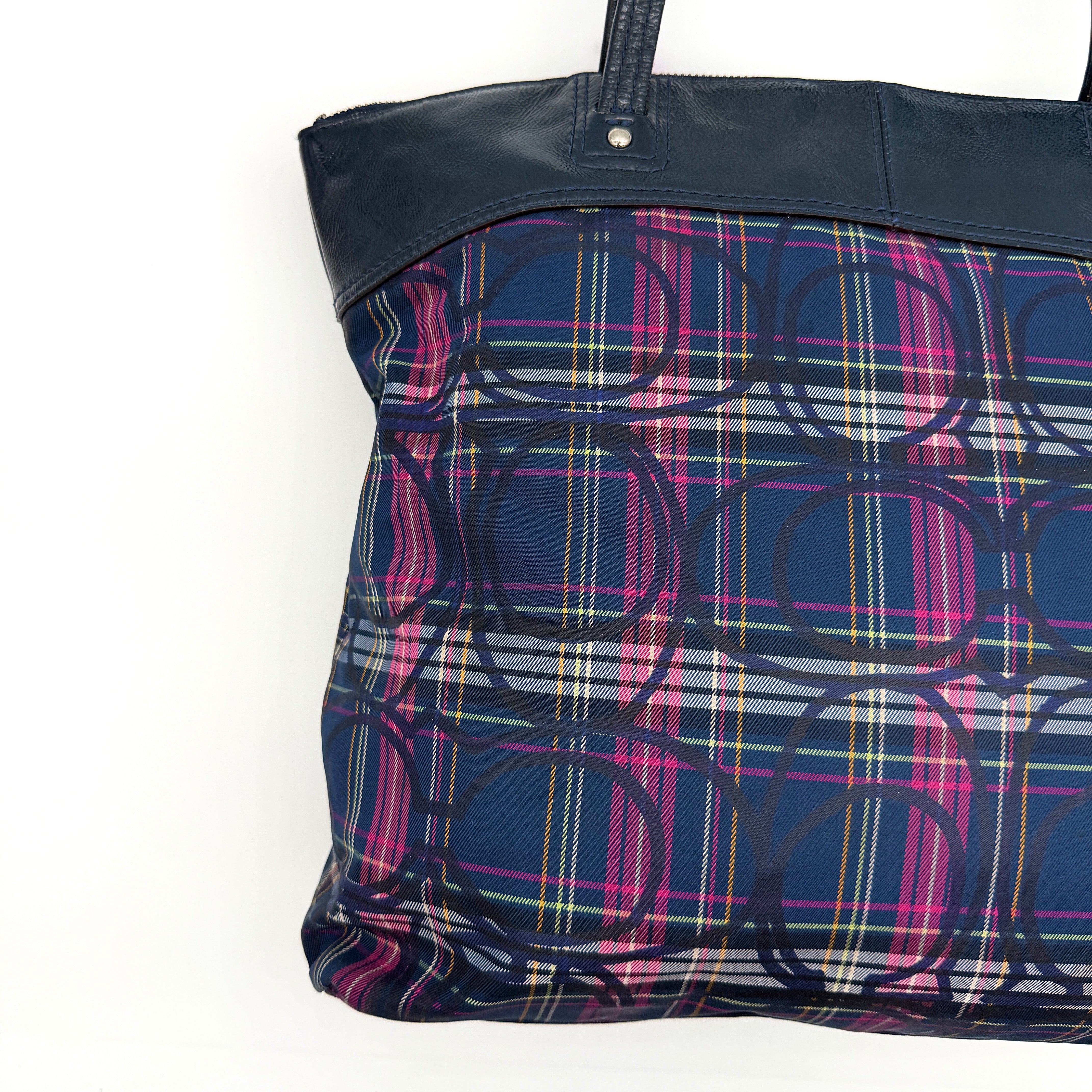 Coach Signature Tartan Plaid Tote Bag in navy, pink and yellow plaid with embossed leather circle and black leather trim.