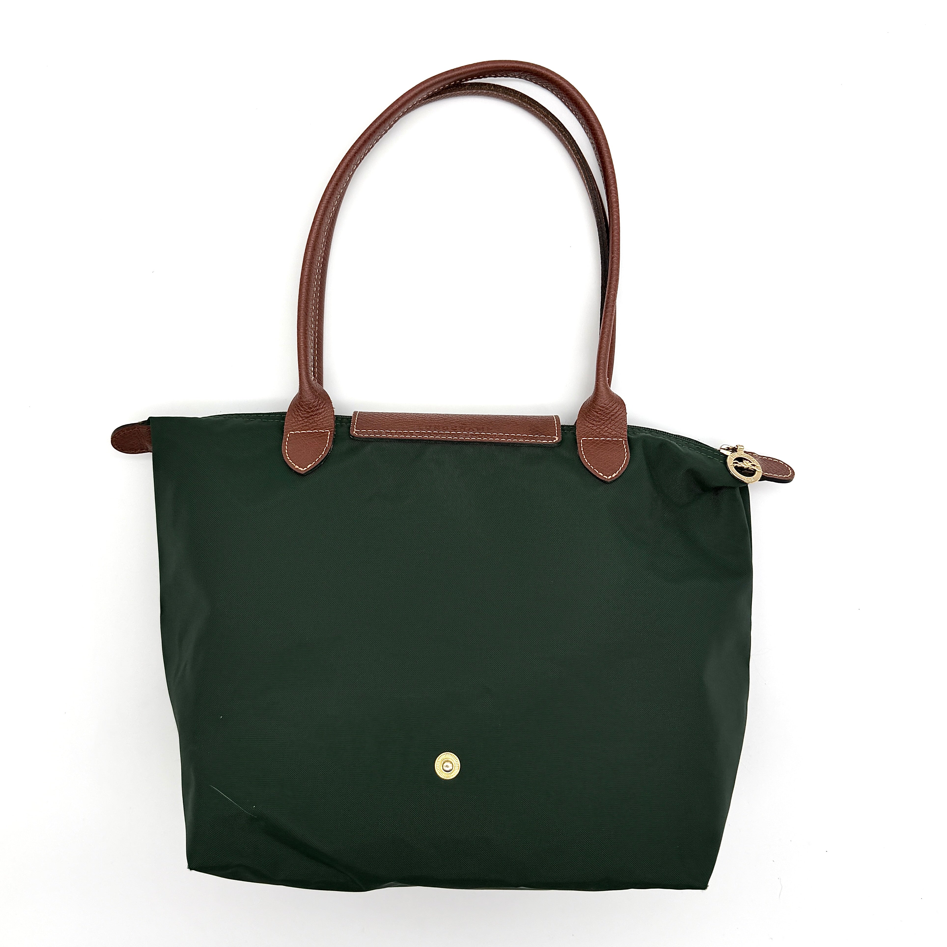 Longchamp Le Pliage Original Tote in green nylon with brown leather handles and gold hardware displayed against a white background.