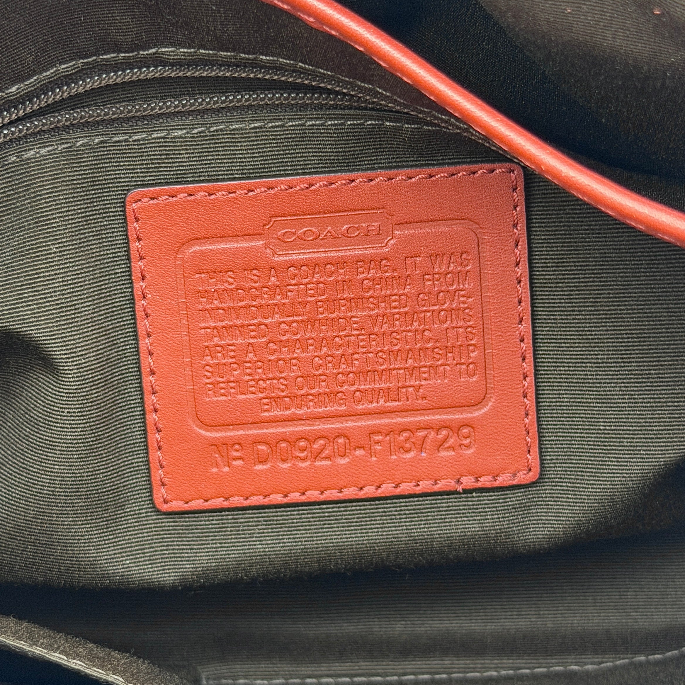 Coach Soho bag in burnt orange leather with pleated detailing and wide shoulder strap, shown on a white background.