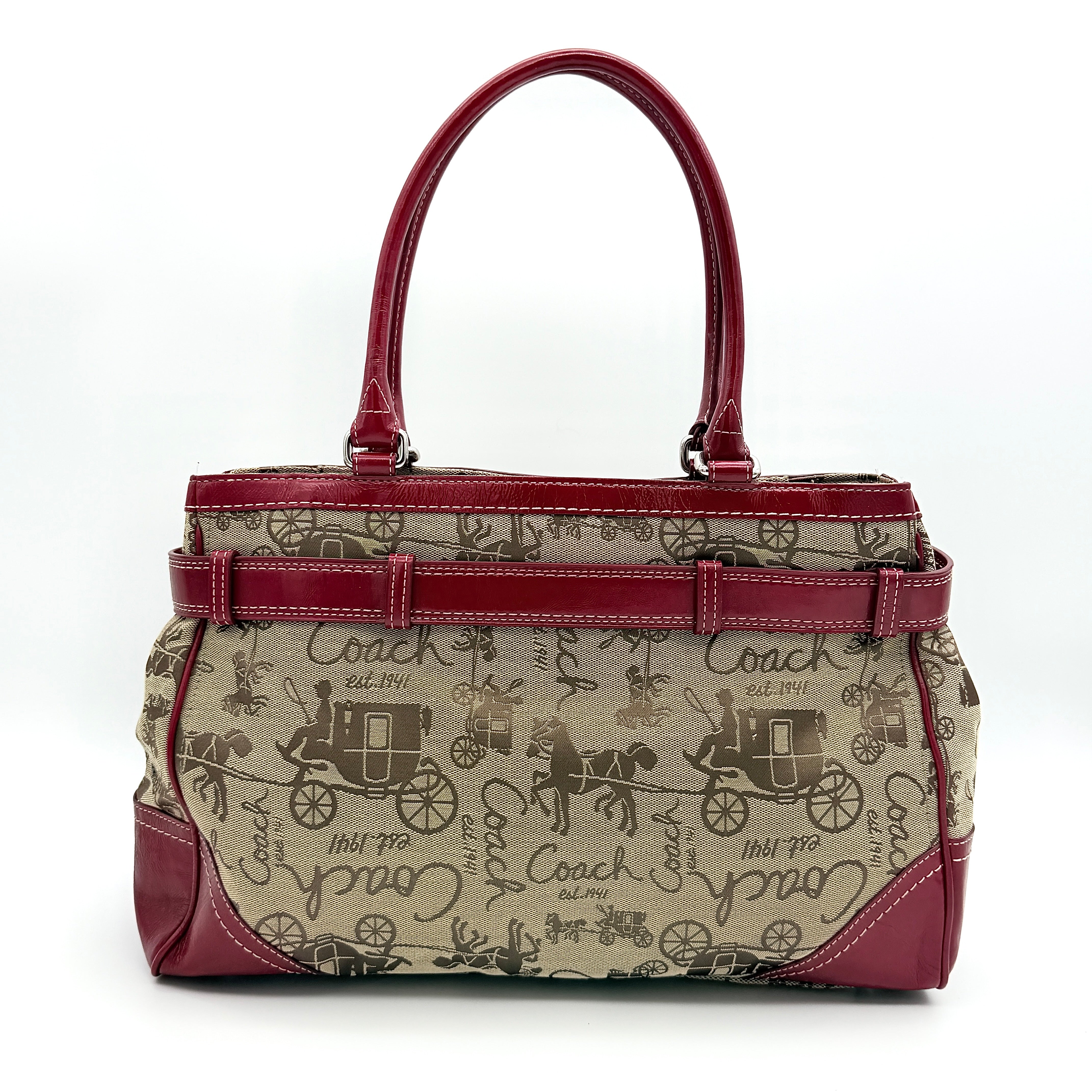 Coach Hampton Carryall in beige canvas with horse carriage motif, red leather trim, and double handles.