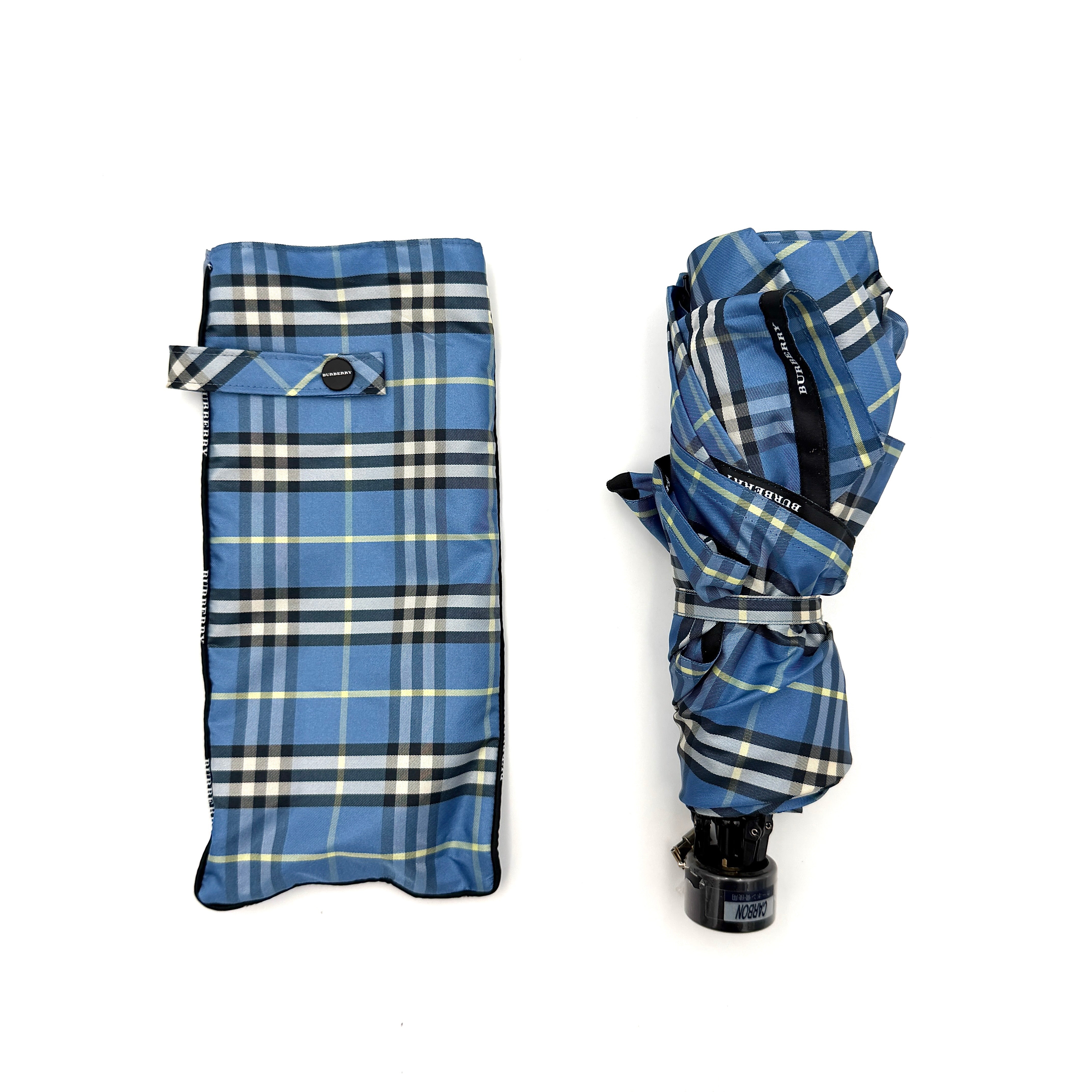 Burberry folding umbrella and matching pouch in blue Nova Check plaid, perfectly folded to showcase its classic pattern and refined finish.