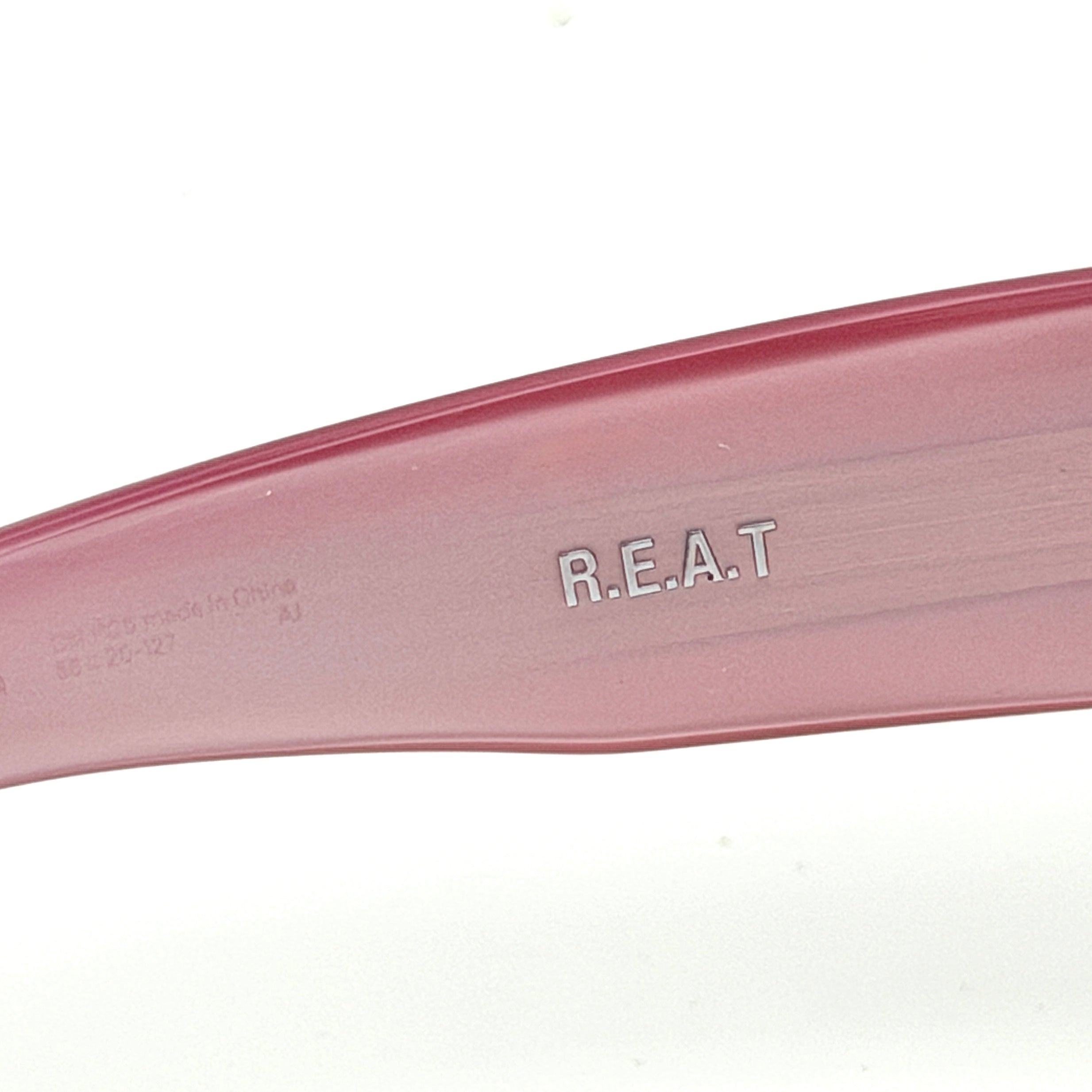 Gentle Monster R.E.A.T sunglasses in translucent pink acetate with mirrored pink lenses and silver star hardware, displayed alongside a chrome hard case.