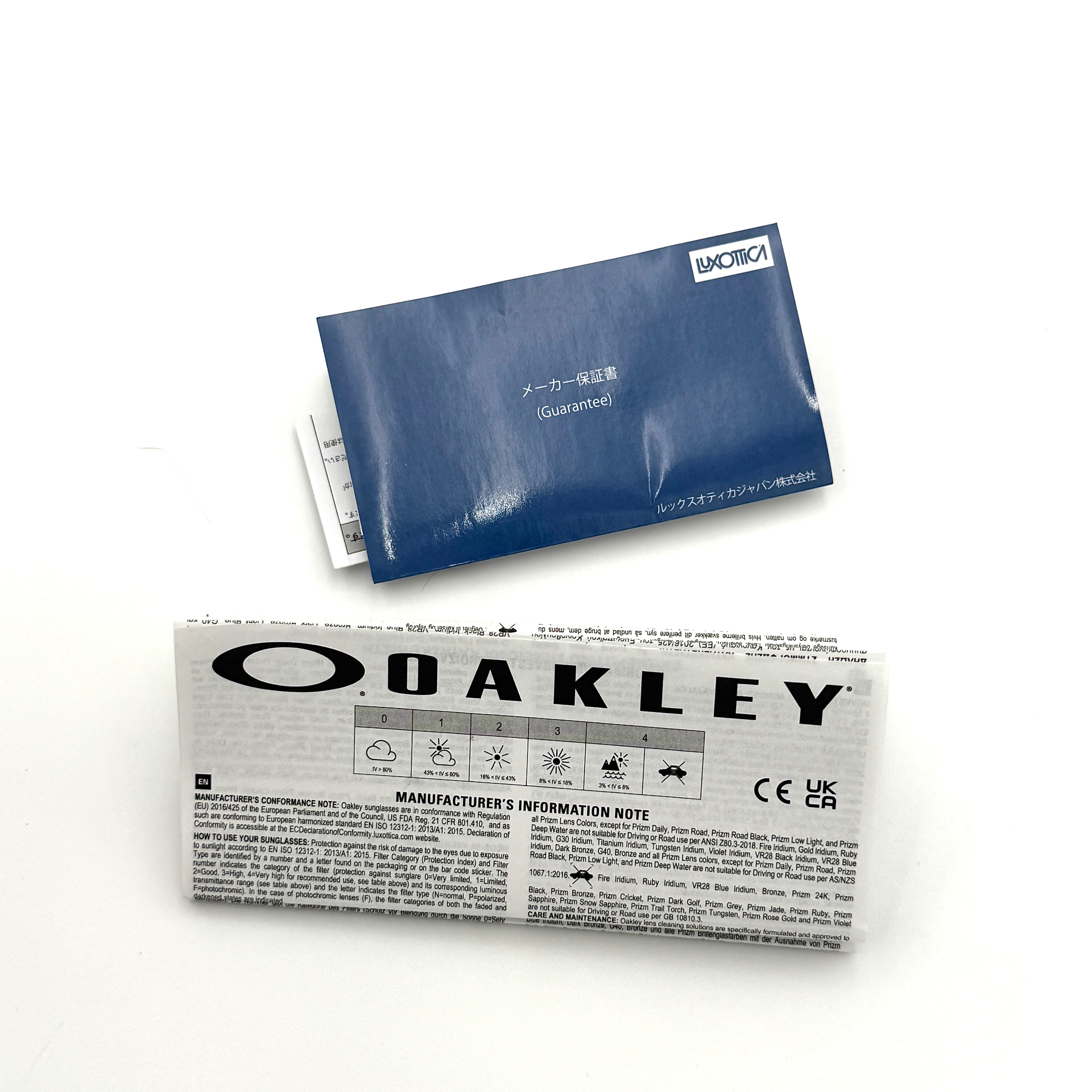 Oakley RadarLock Path sunglasses in matte black with reflective green and violet Prizm shield lens, presented with original black case, box, and cloth.