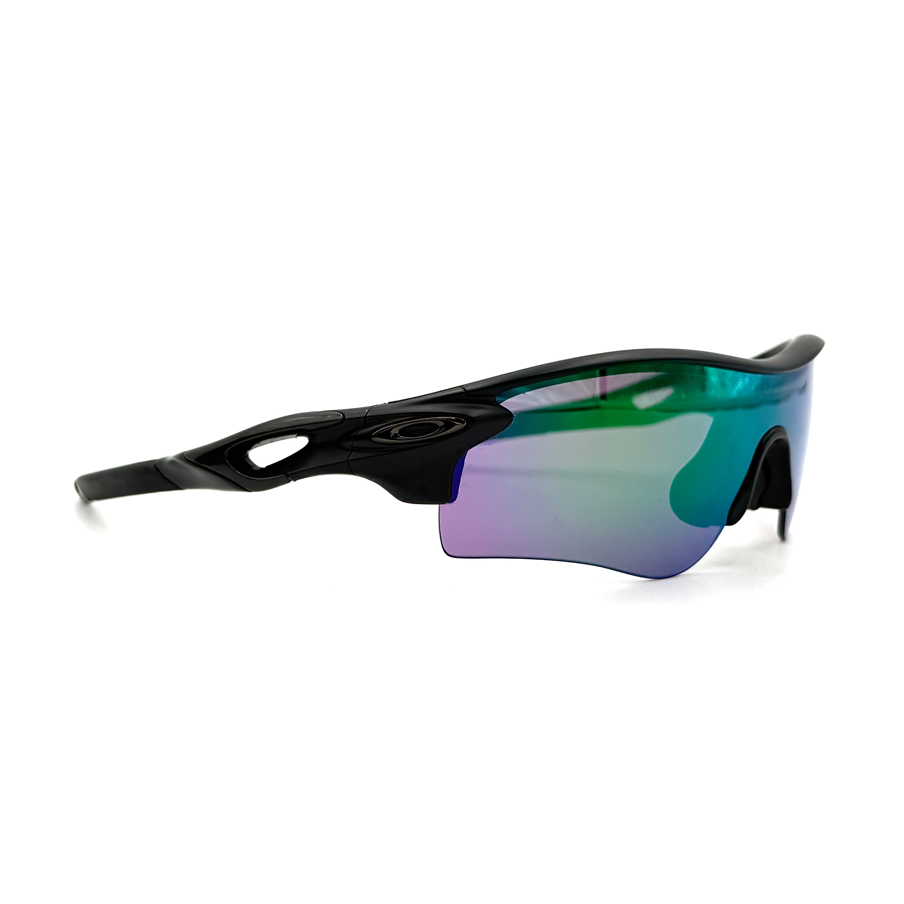 Oakley RadarLock Path sunglasses in matte black with reflective green and violet Prizm shield lens, presented with original black case, box, and cloth.